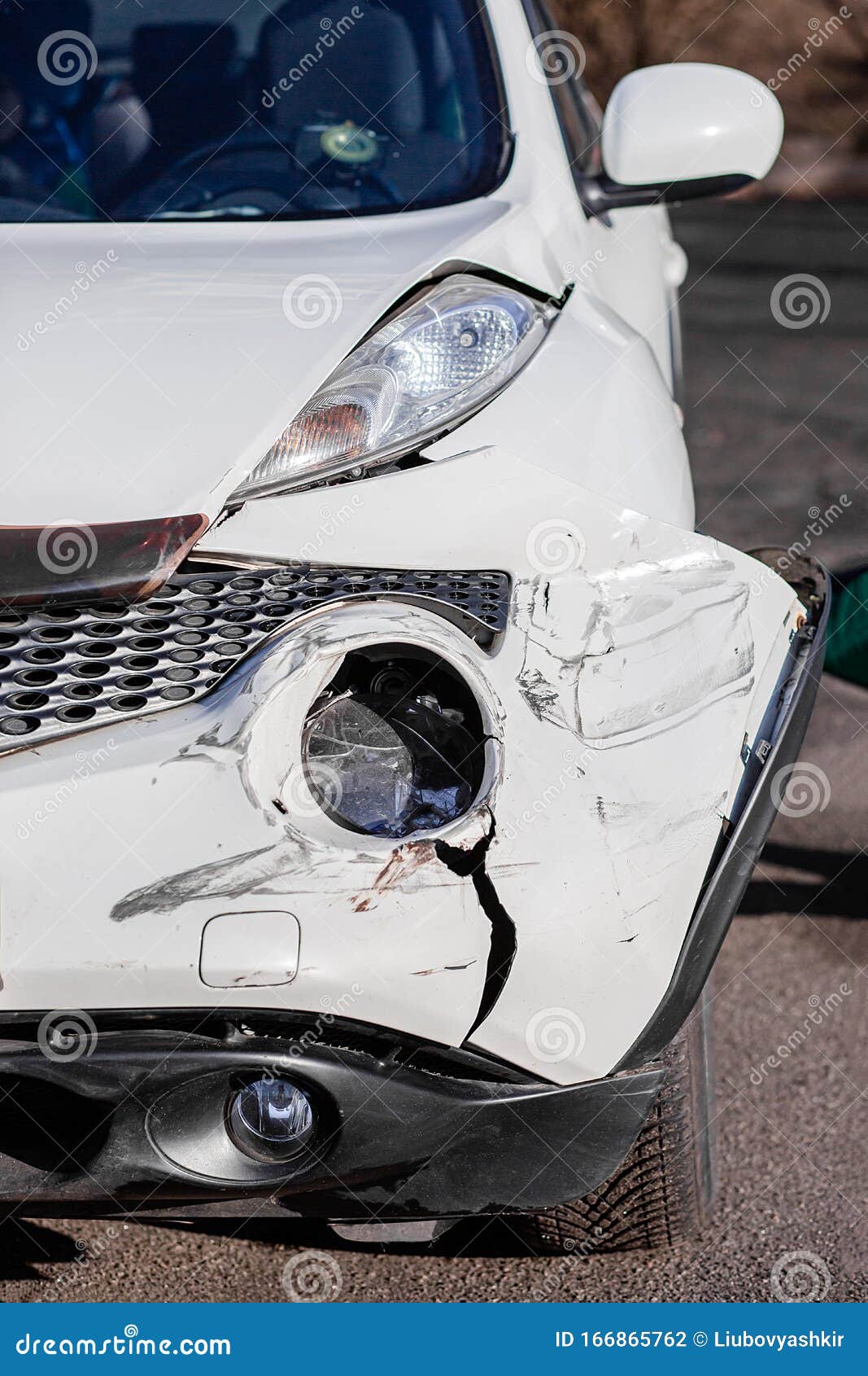 Broken Car after a Crash. Damaged Wing and Headlamp of a Car