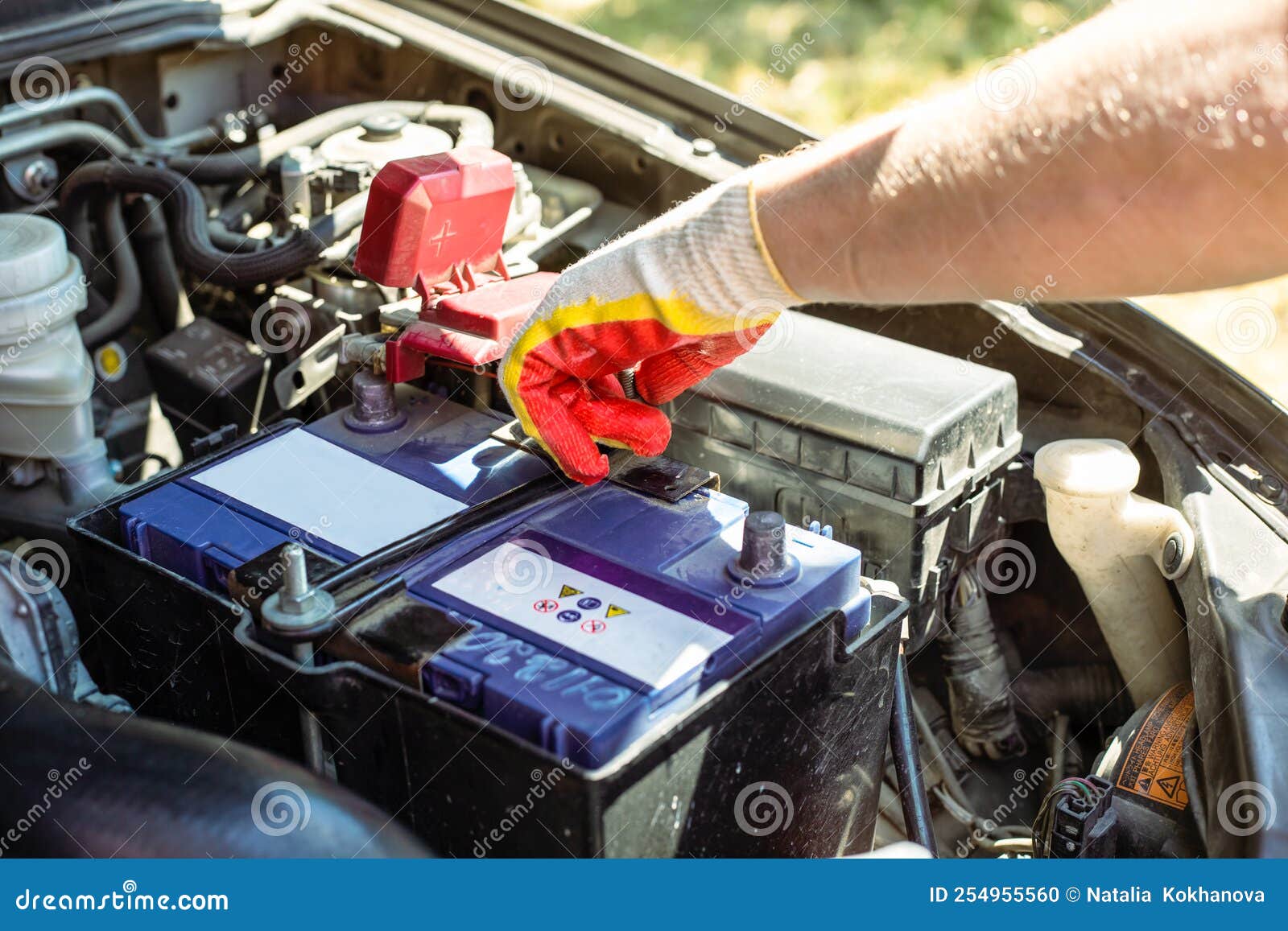 Car Battery Replacement. the Car Mechanic Repairs the Car, Unscrews the
