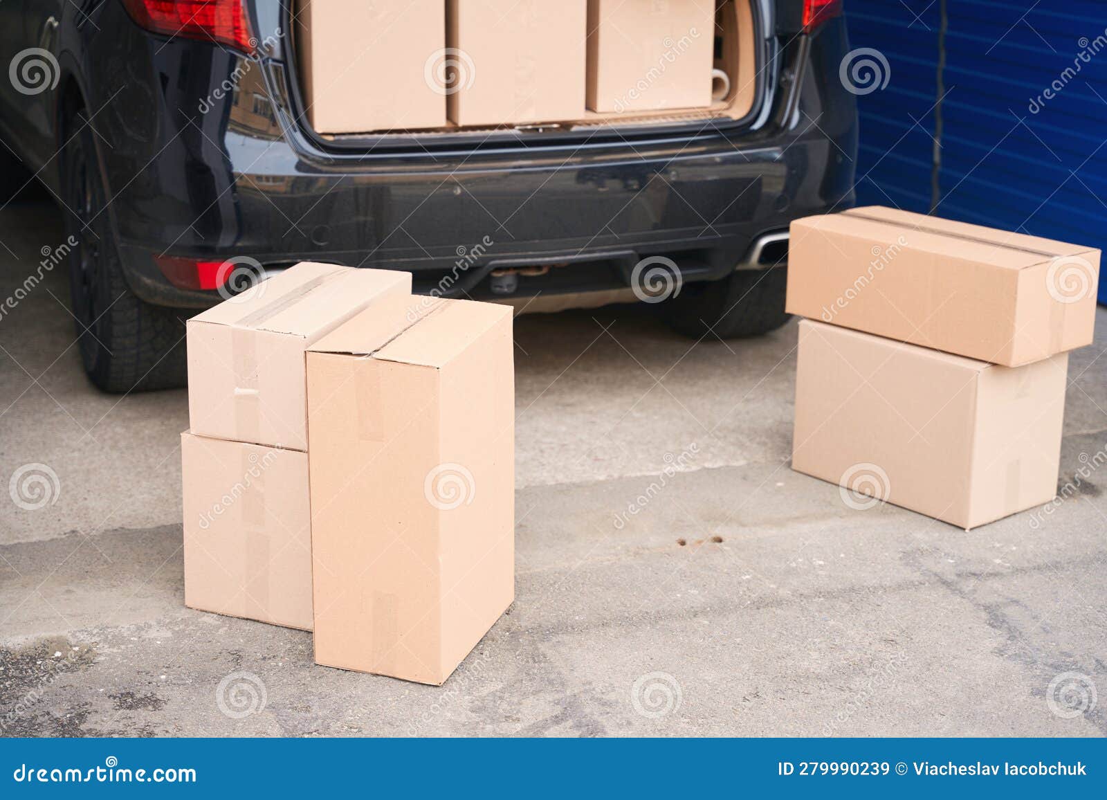 Car with Cardboard Boxes in the Trunk in a Warehouse with Selfstorage