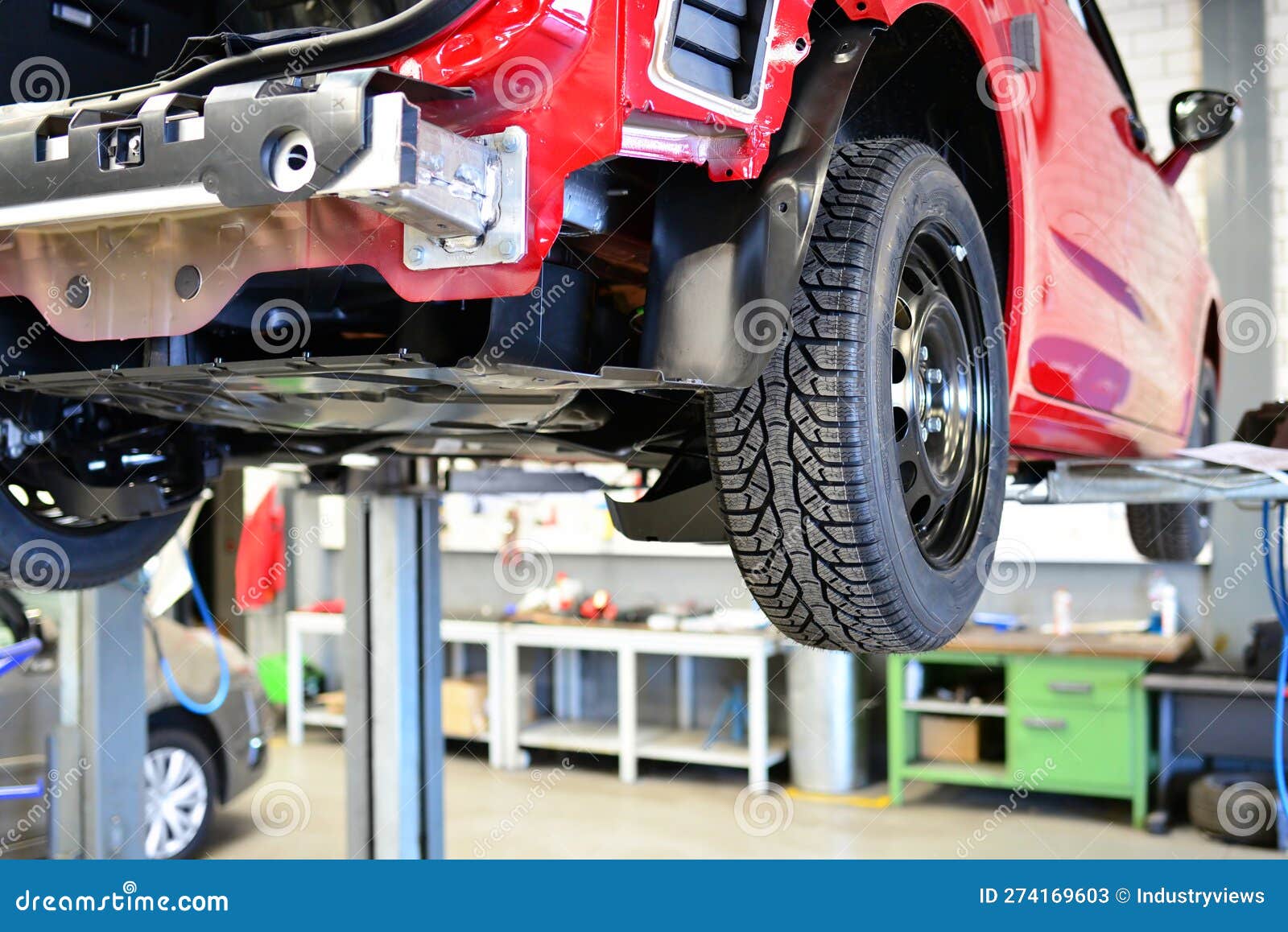 Car for Changing Tyres on a Lifting Platform in the Closeup