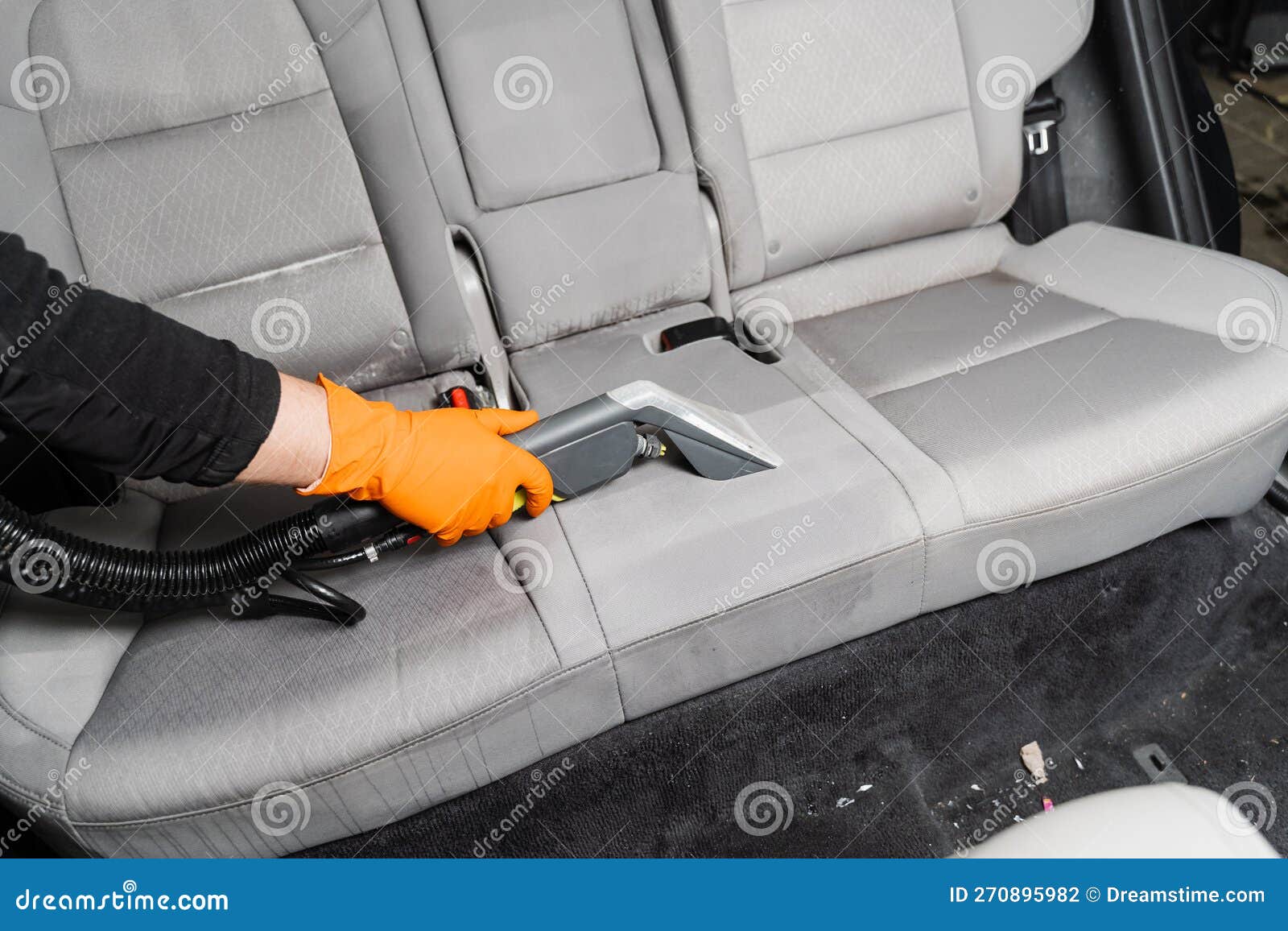 Car Cleaner is Extracting Dirt from Car Seat Using Dry Cleaning
