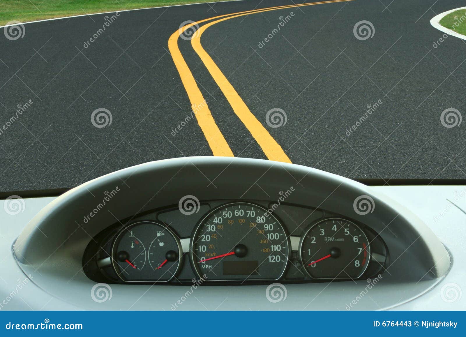 car dashboard and curvy road
