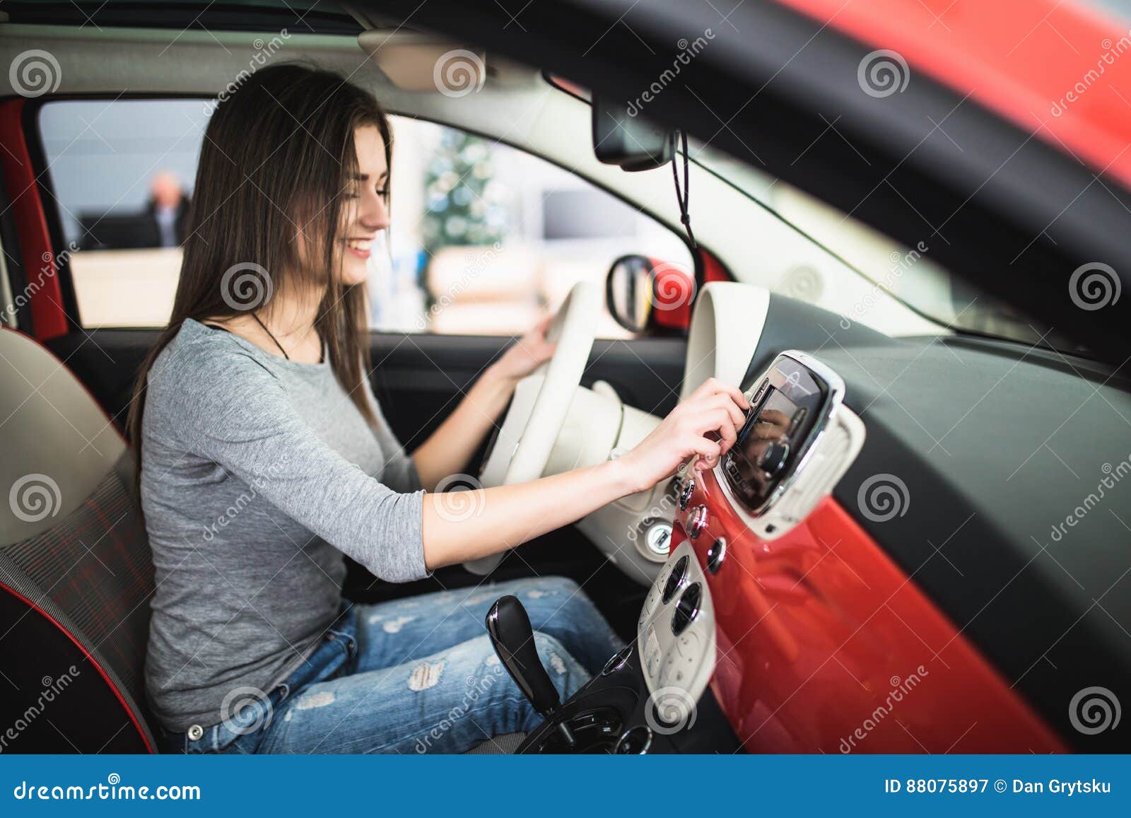 Woman Turning Button Of Radio In Car Stock Photo - Download Image