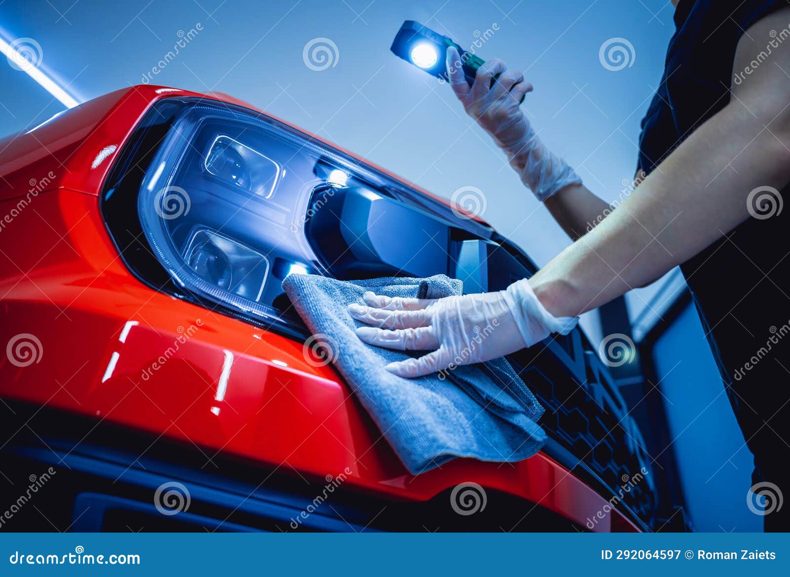 Car Detailing Worker Cleaning and Polishing Car with Microfiber Cloth