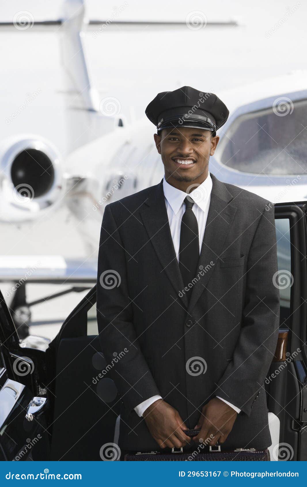 car driver standing by car at airfield