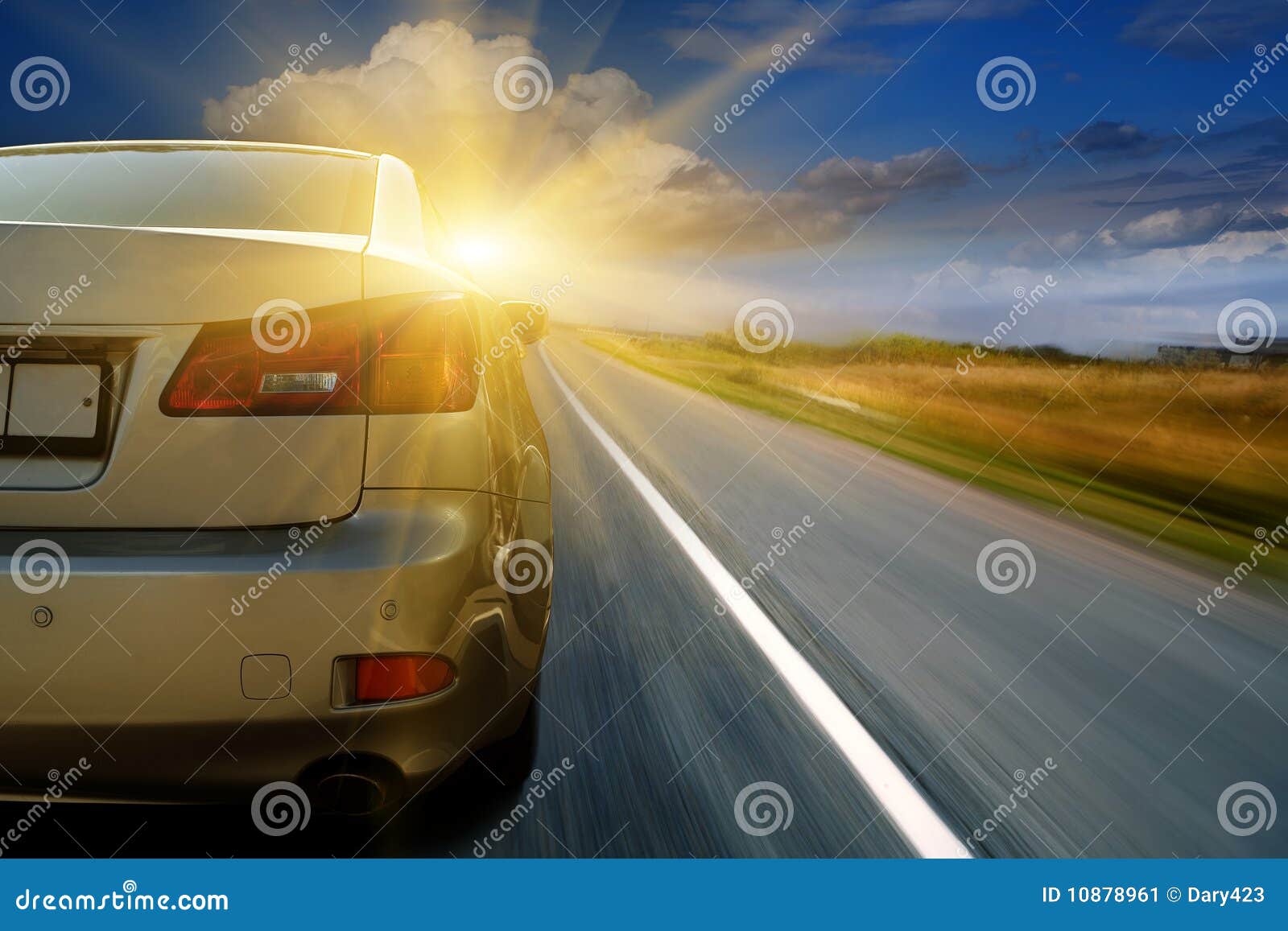 car driving towards sunshine