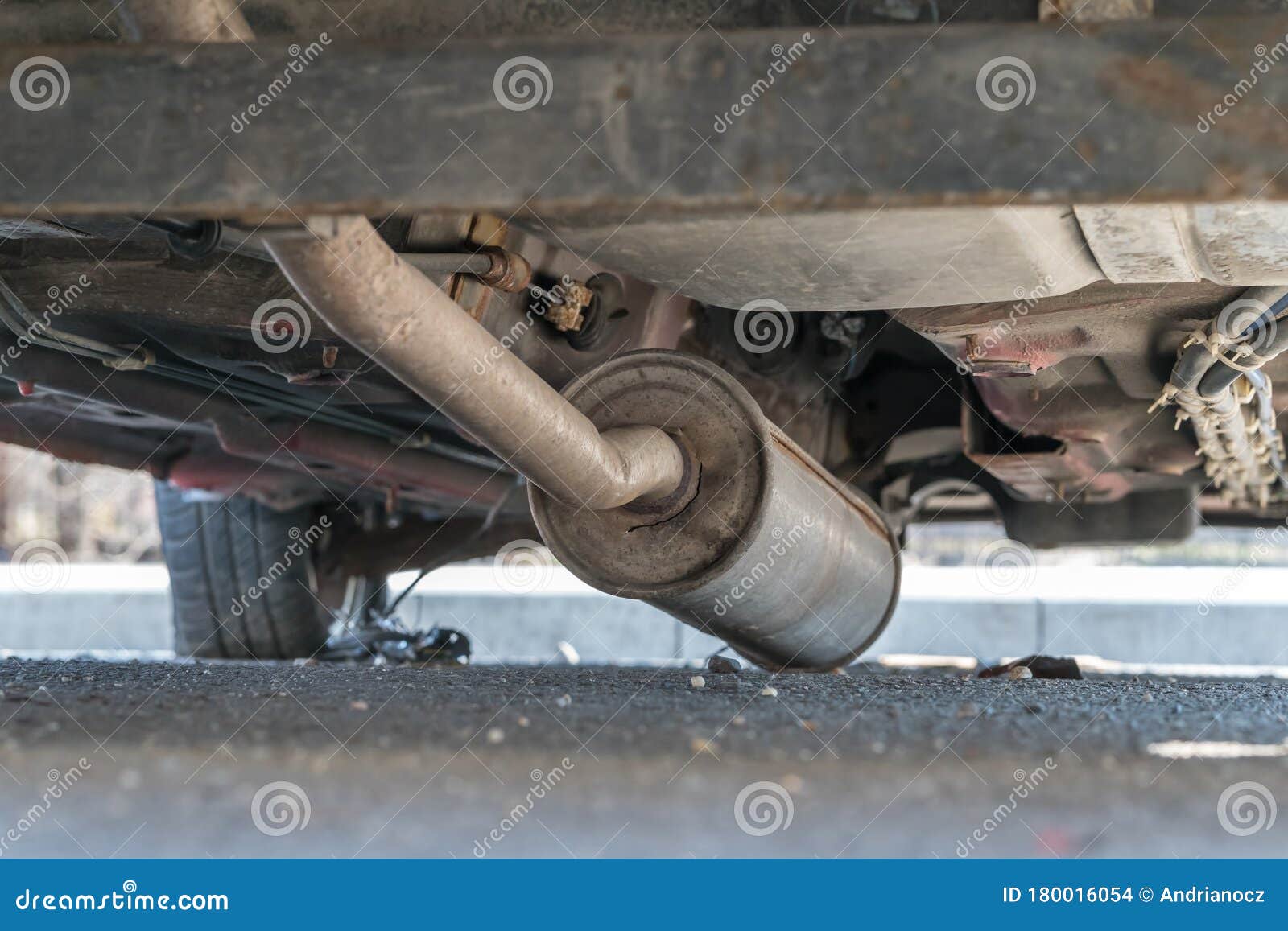 Car Exhaust, Muffler Fallen Down View of Chassis of a Car Stock Photo