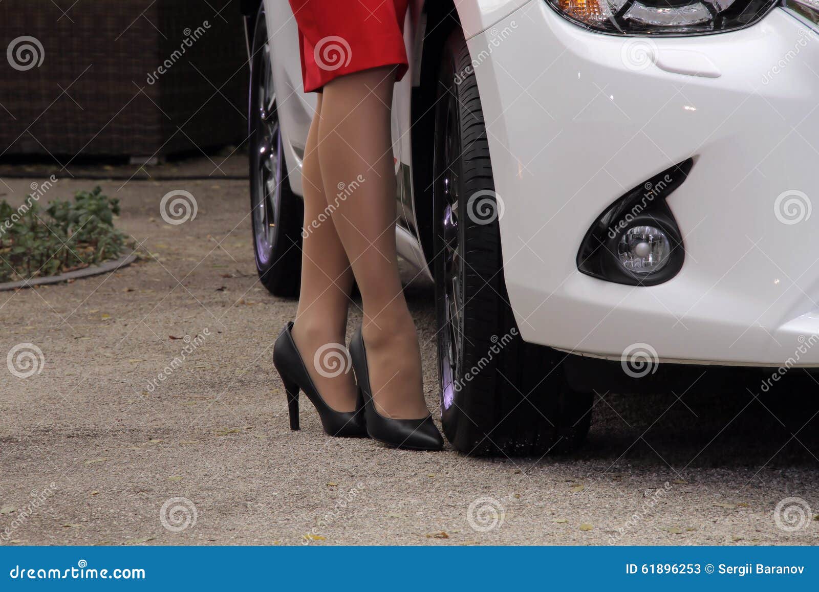 Car and Fashion. Woman on High Heel Shoes Near Car on Gravel Footpath ...
