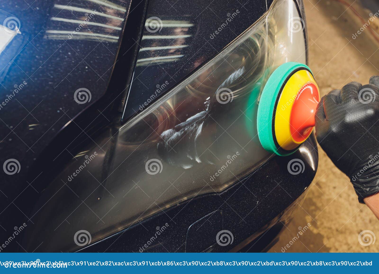 Car Headlights Cleaning with Power Buffer Machine at Car Service. Stock