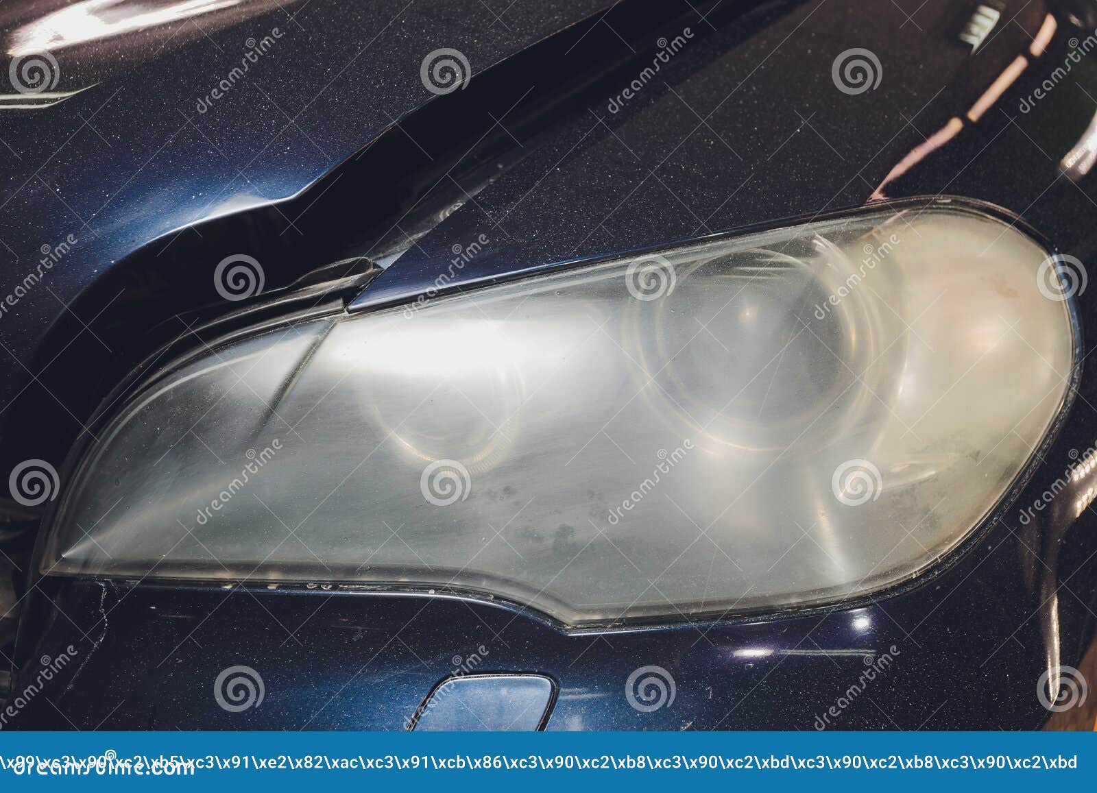 Car Headlights Cleaning with Power Buffer Machine at Car Service. Stock