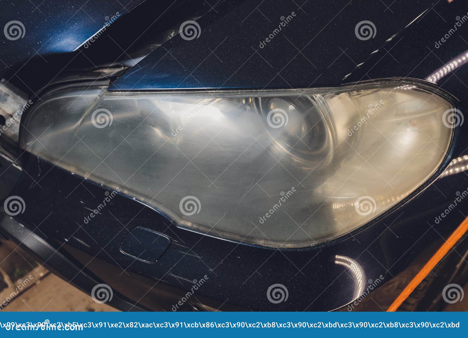 Car Headlights Cleaning with Power Buffer Machine at Car Service. Stock