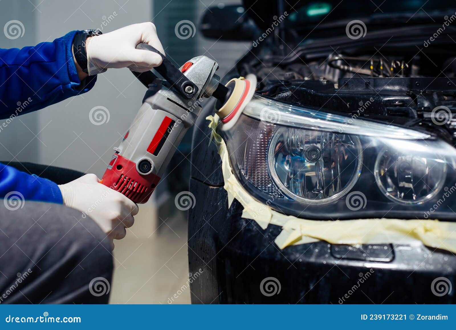 Car Headlights Cleaning with Power Buffer Machine at Car Service Stock