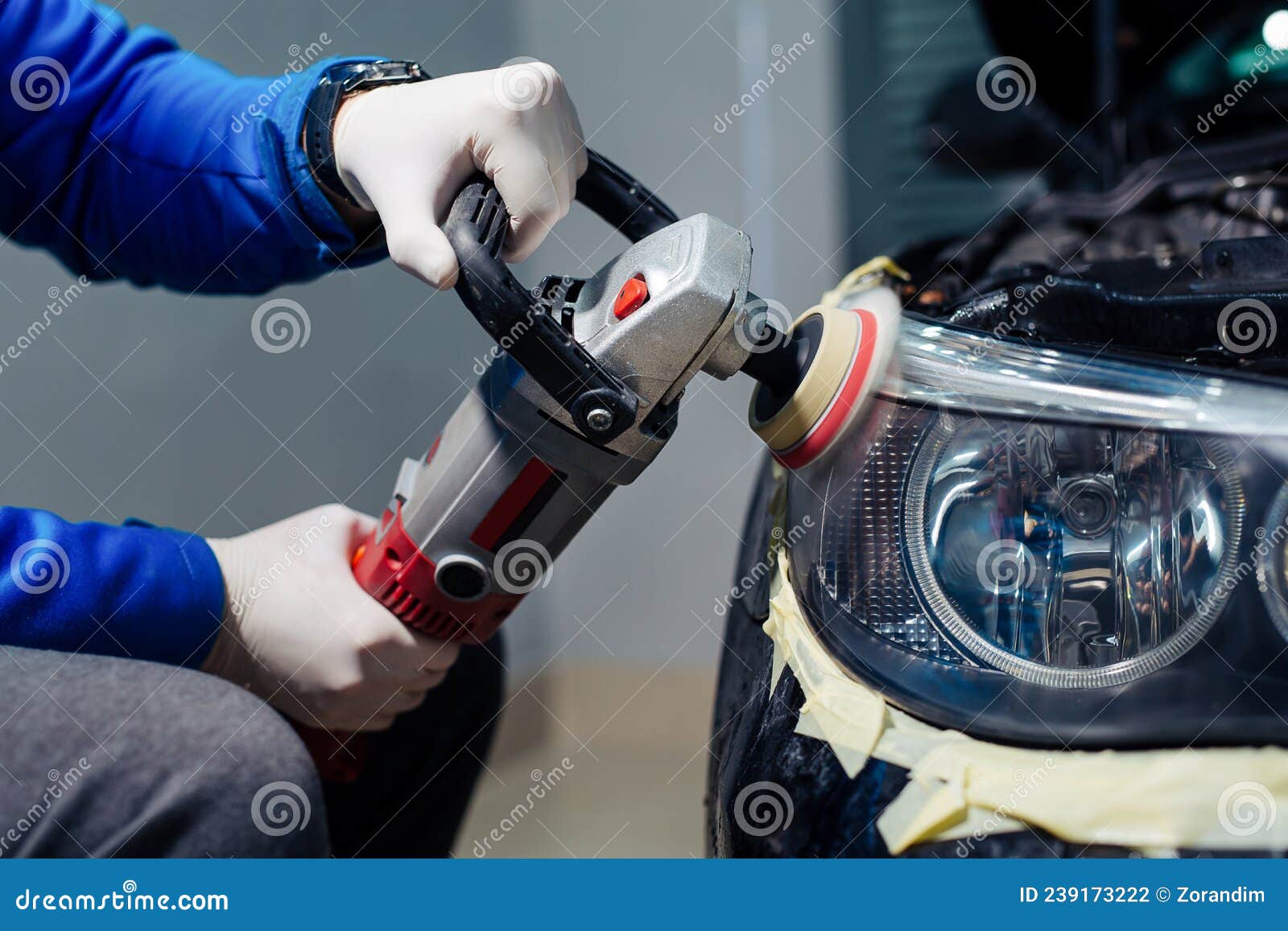 Car Headlights Cleaning with Power Buffer Machine at Car Service Stock