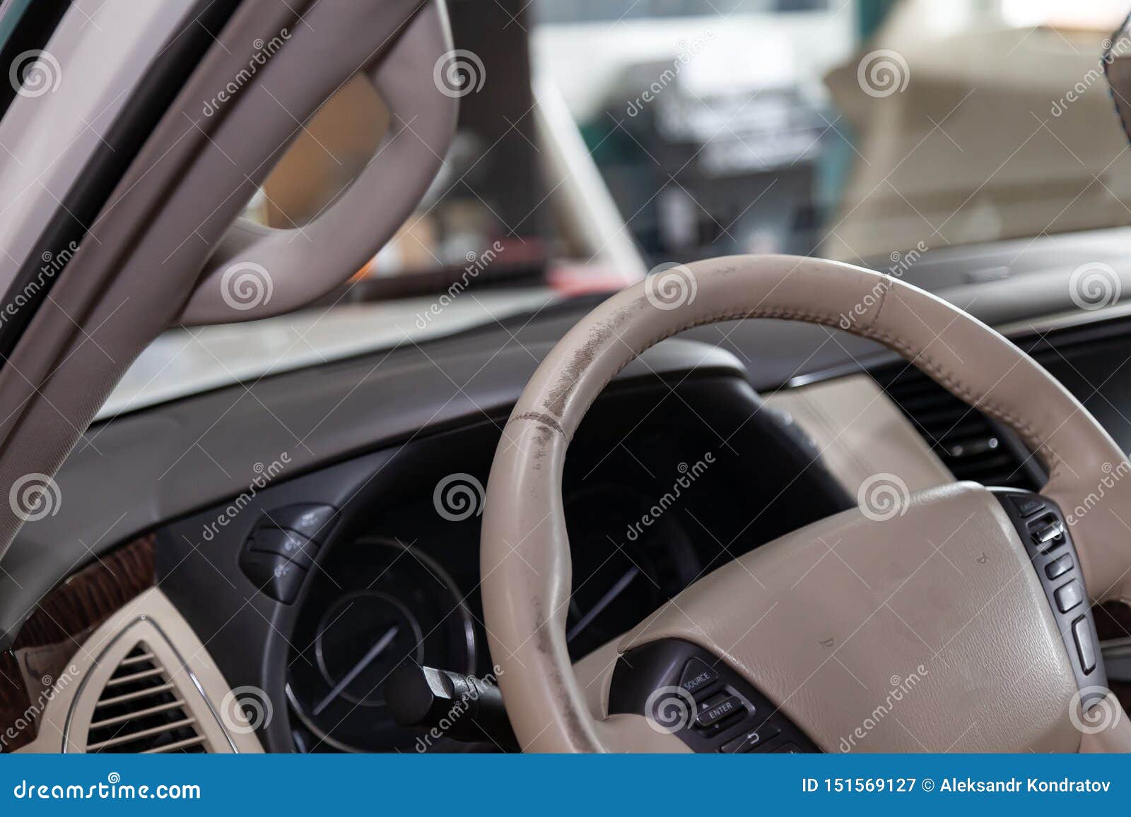 Car Interior With A Beige Leather Steering Wheel Close Up