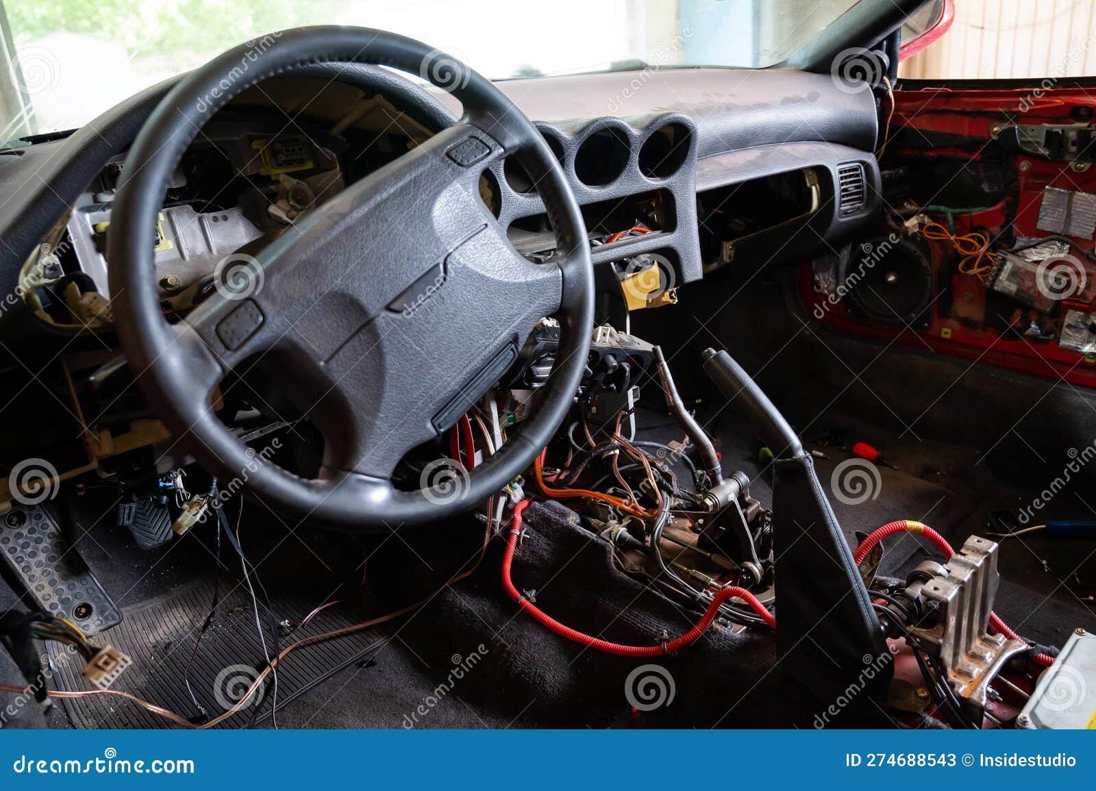 Car Interior with Disassembled Electrics in the Garage. Stock Image