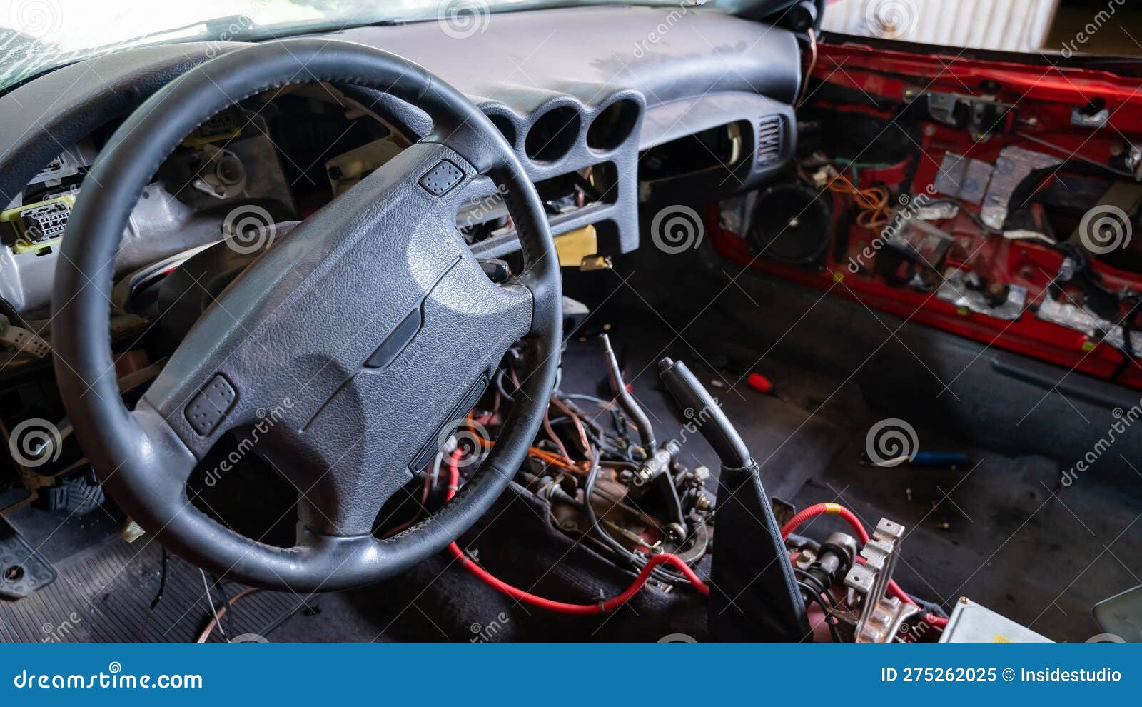 Car Interior with Disassembled Electrics in the Garage. Stock Image