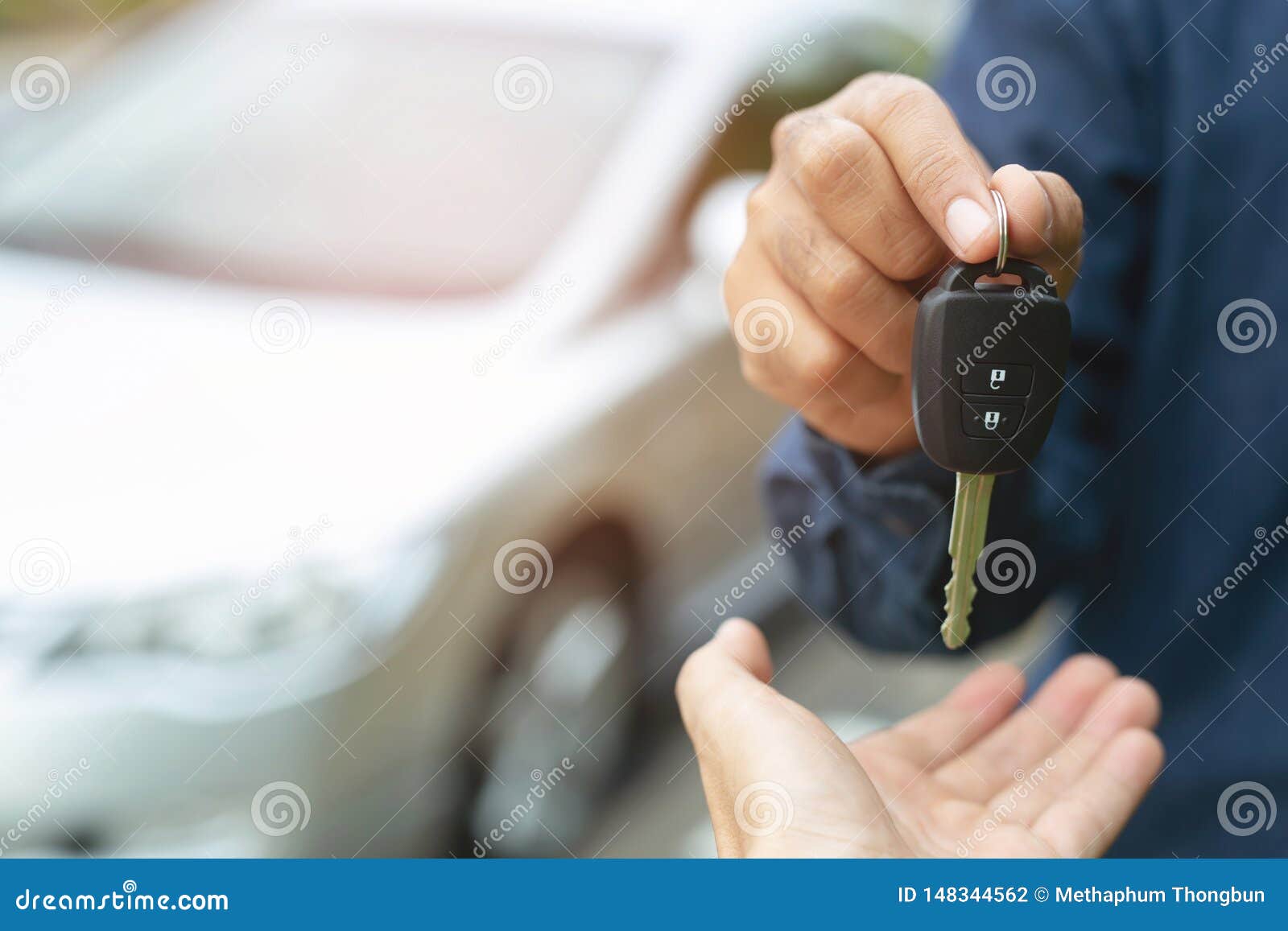 car key, businessman handing over gives the car key to the other woman