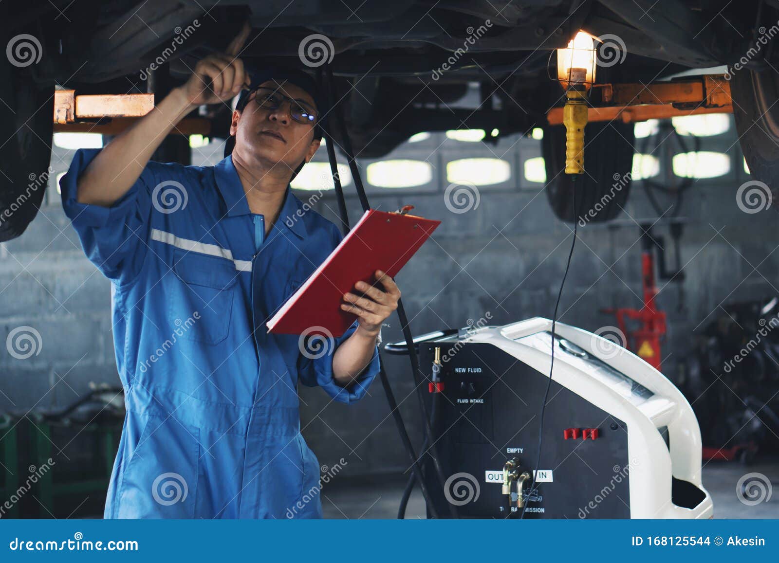 car mechanic checking and having car transmition maintenance service at garage and service station