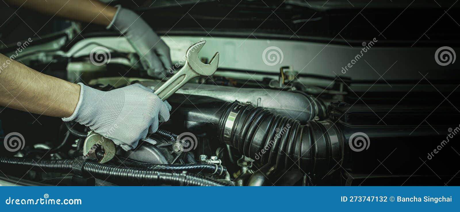 A Car Mechanic is Doing a Car Repair in a Repair Shop Stock Photo