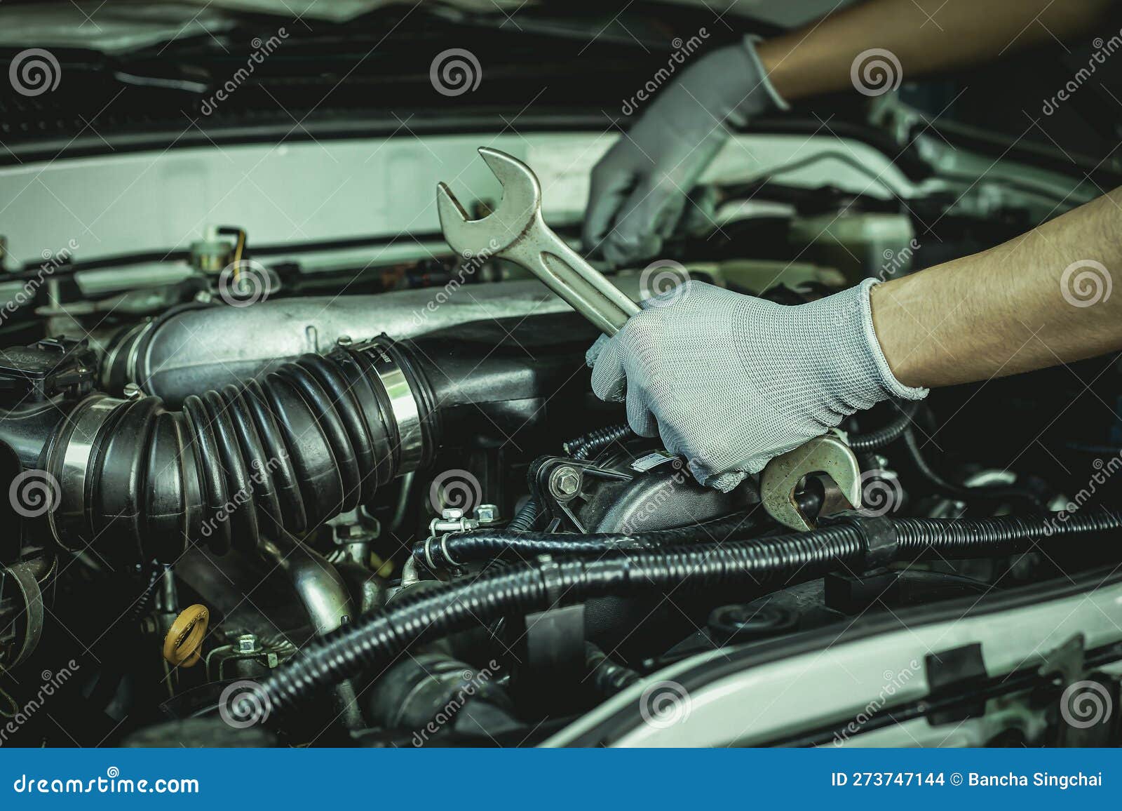 A Car Mechanic is Doing a Car Repair in a Repair Shop Stock Photo
