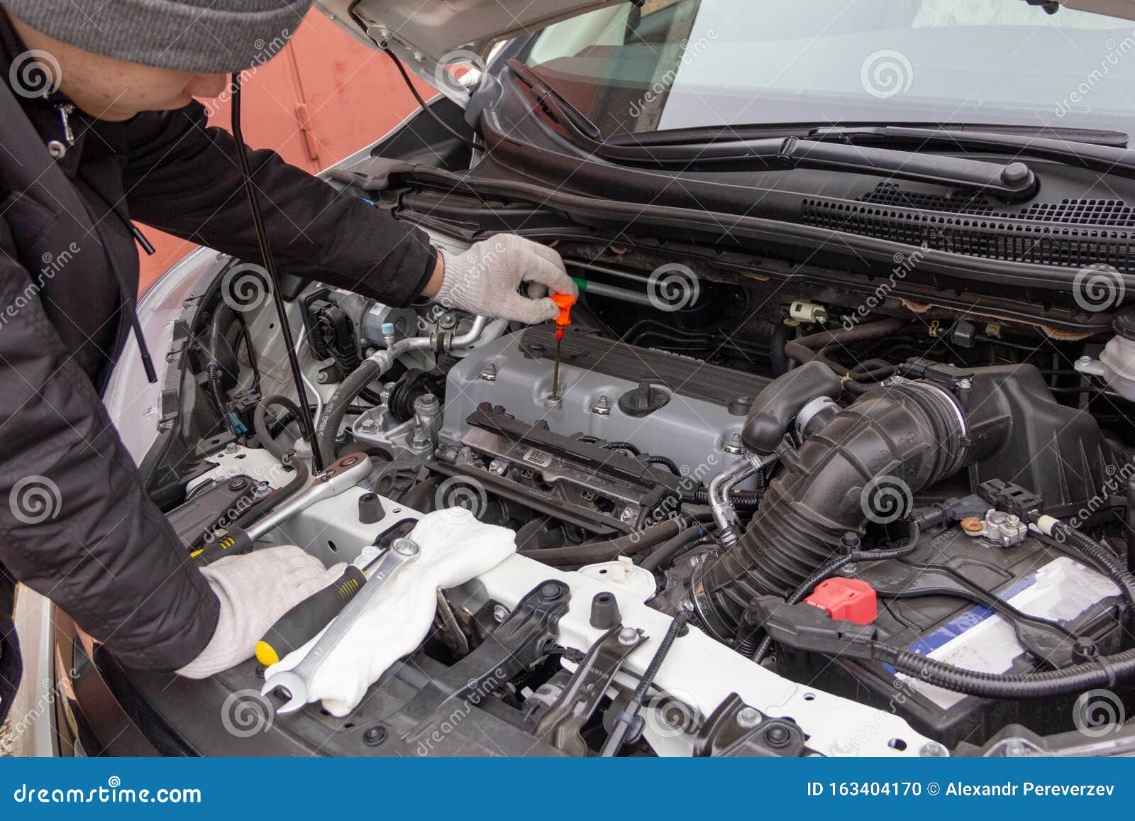 The Car Mechanic is Engaged in Repair of Cars Repair Oil Change Change
