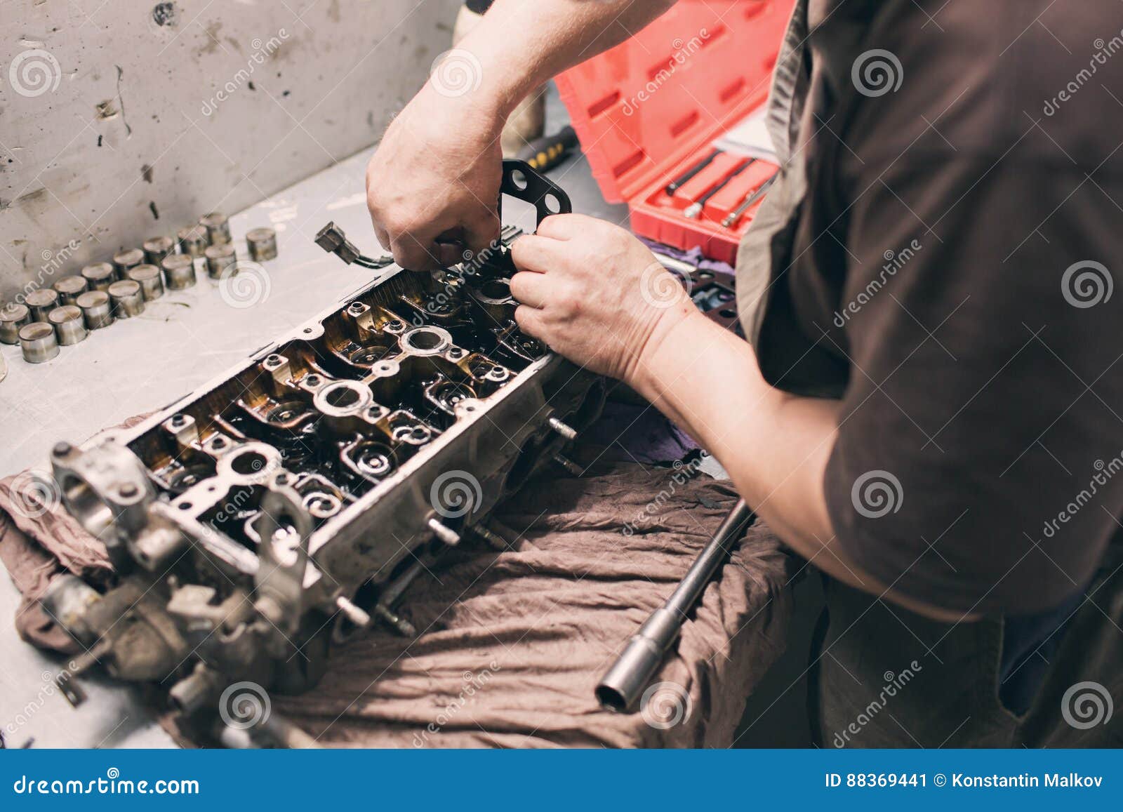 Car Mechanic in Garage with Old Car Engine Piston and Valve Stock Image