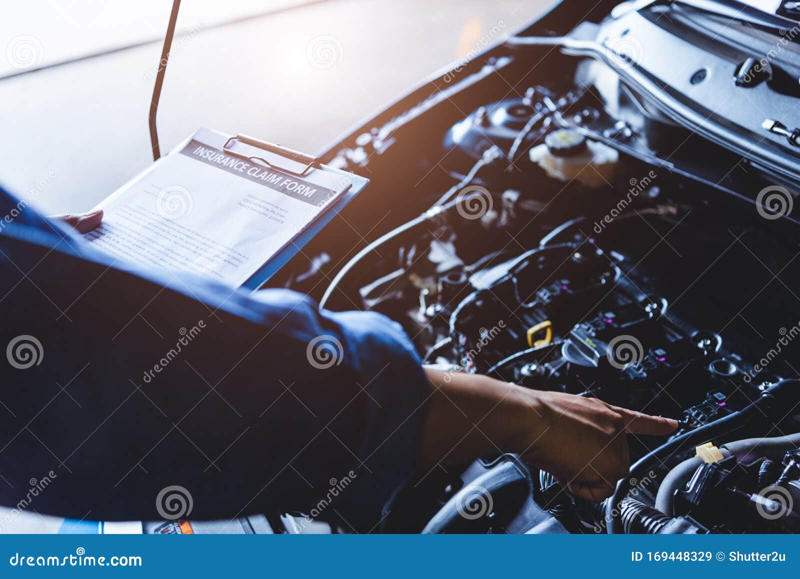 Car Mechanic Holding Clipboard And Checking To Maintenance Vehicle By