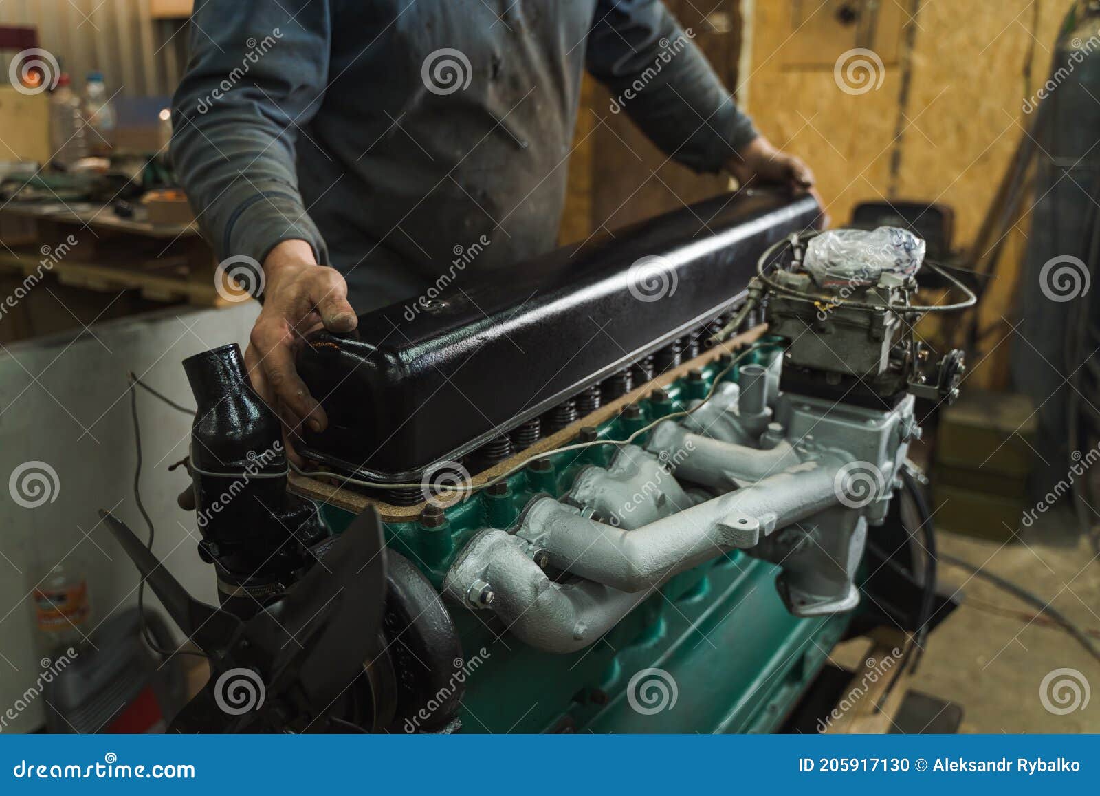 Car Mechanic Repairing an Engine. Mechanic Working on Car Engine