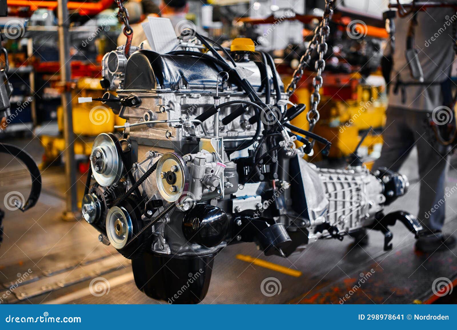 Car Motor Hangs on Chains in Assembling Plant Stock Image