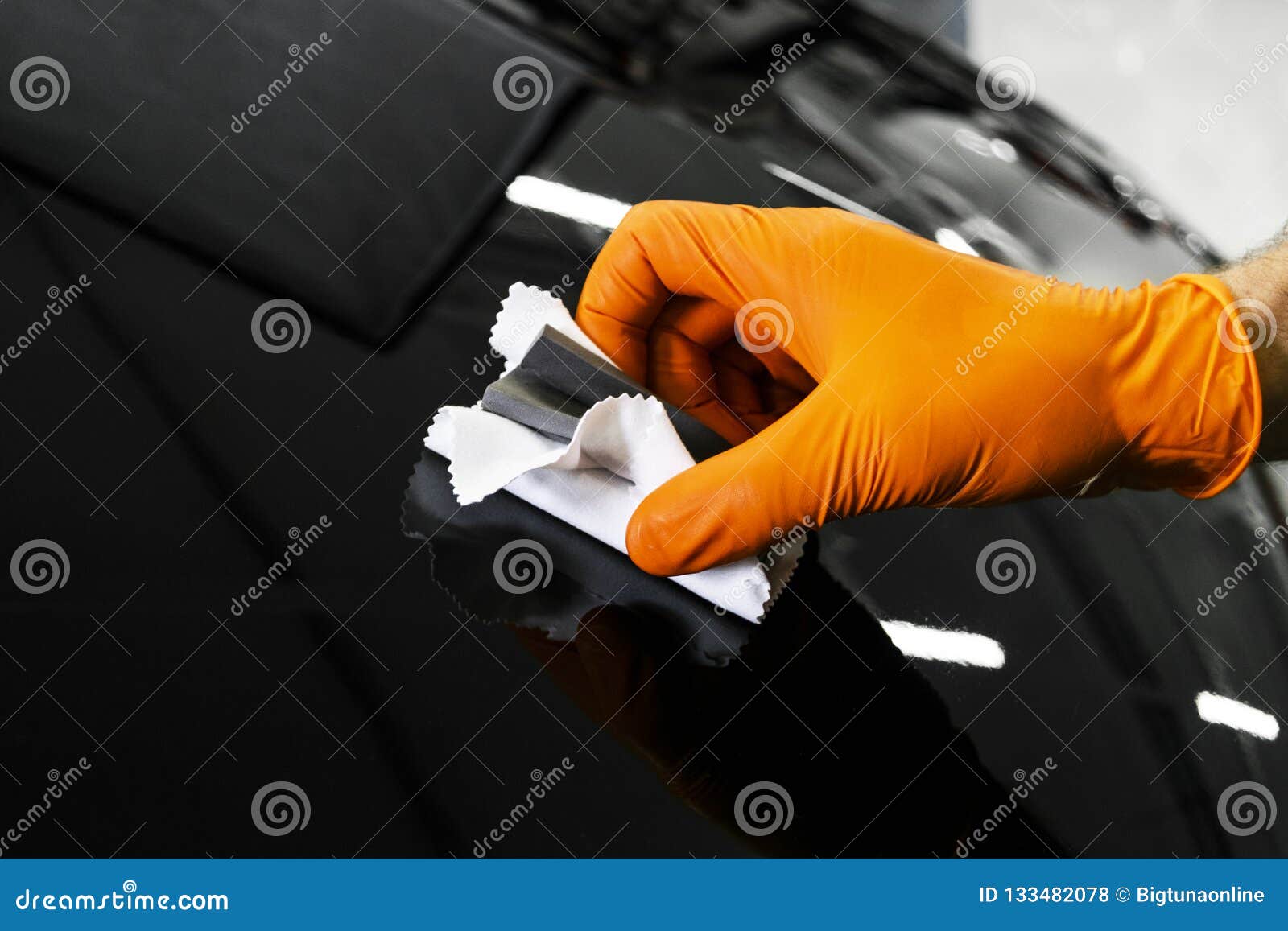 car polish wax worker hands polishing car. buffing and polishing vehicle. car detailing. man holds a polisher in the hand and poli