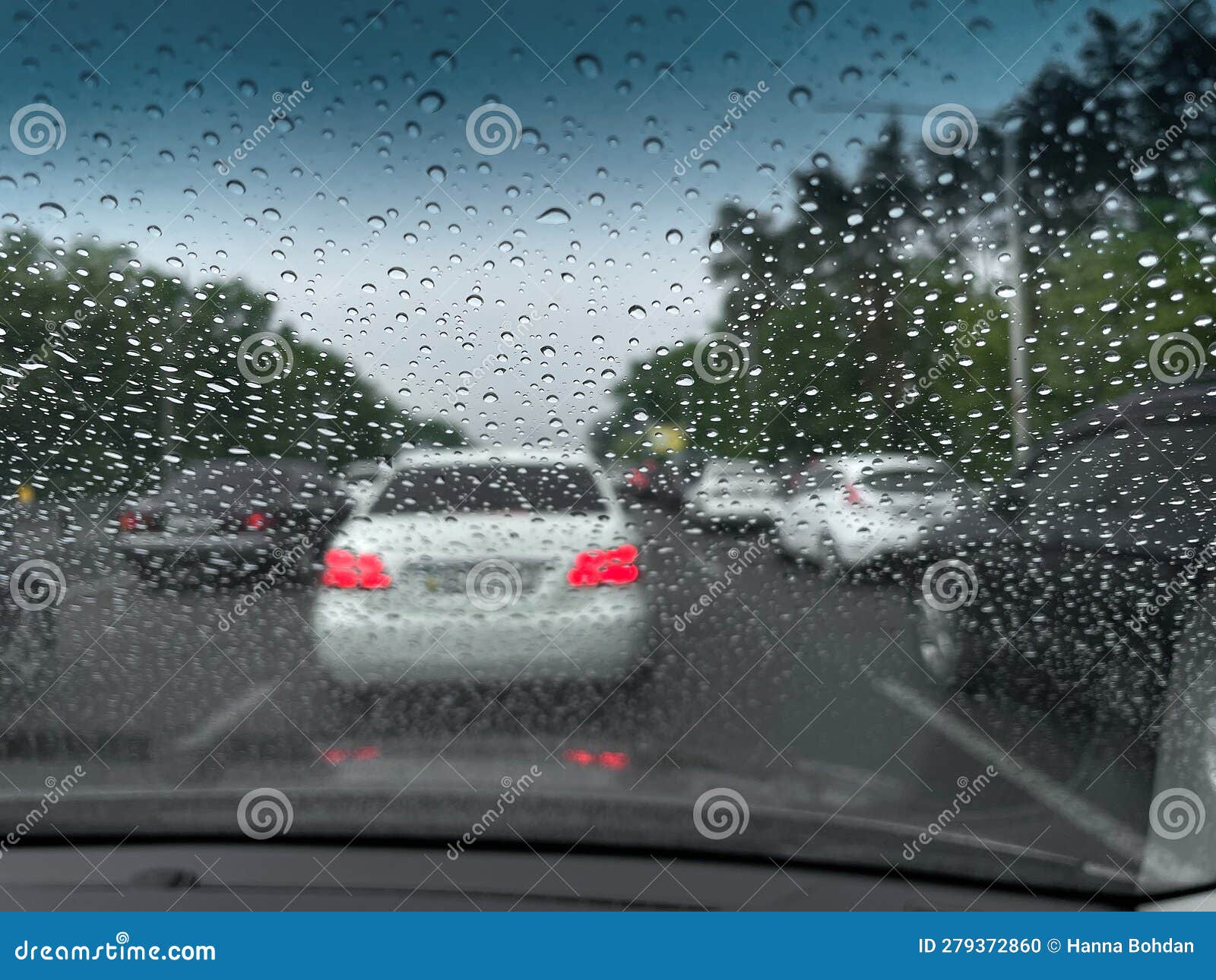 In the Car, Raindrops Run Down the Windshield and the Wipers Work Stock