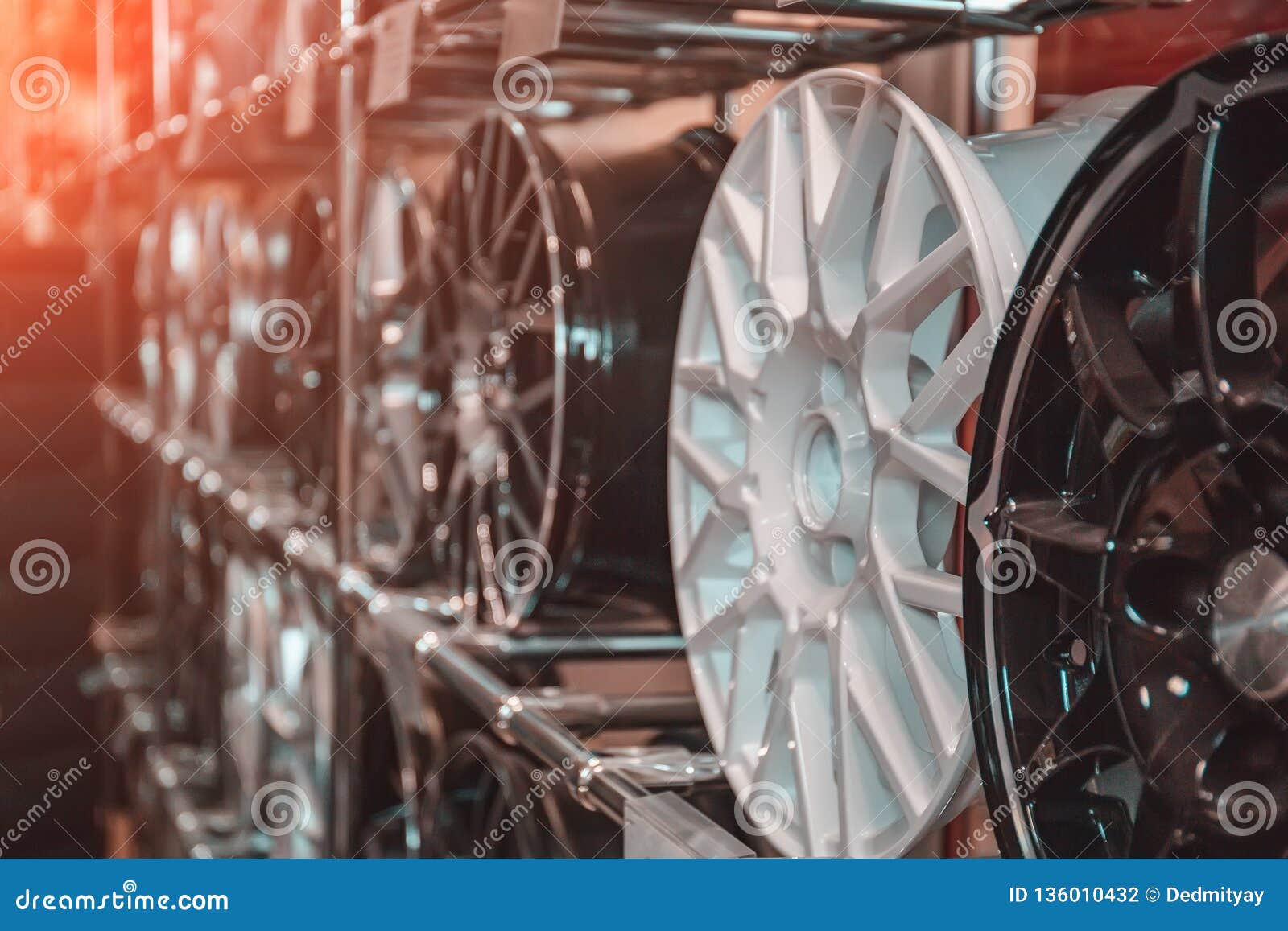 car rims or wheels in store, rows of new alloy automobile disks