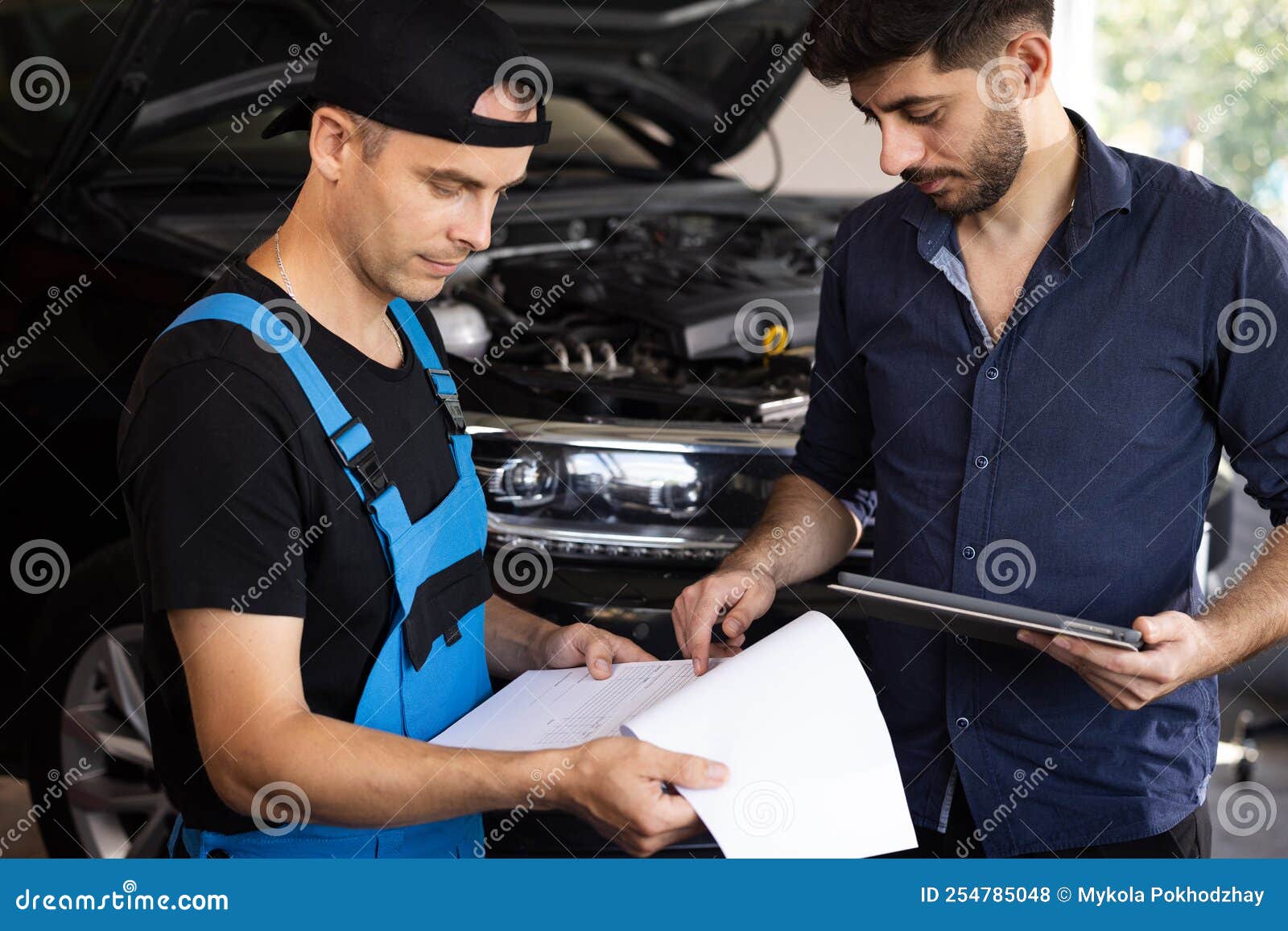 Car Service Employees Inspect the Bottom and Skid Plates of the Car
