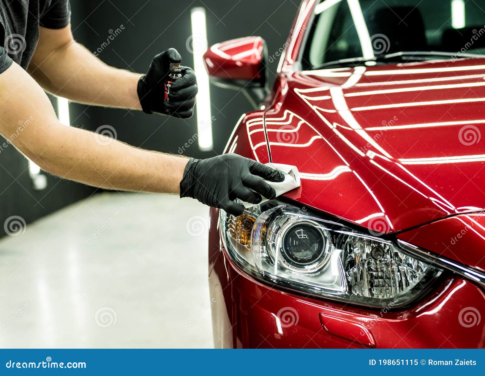 car service worker applying nano coating on a car detail.