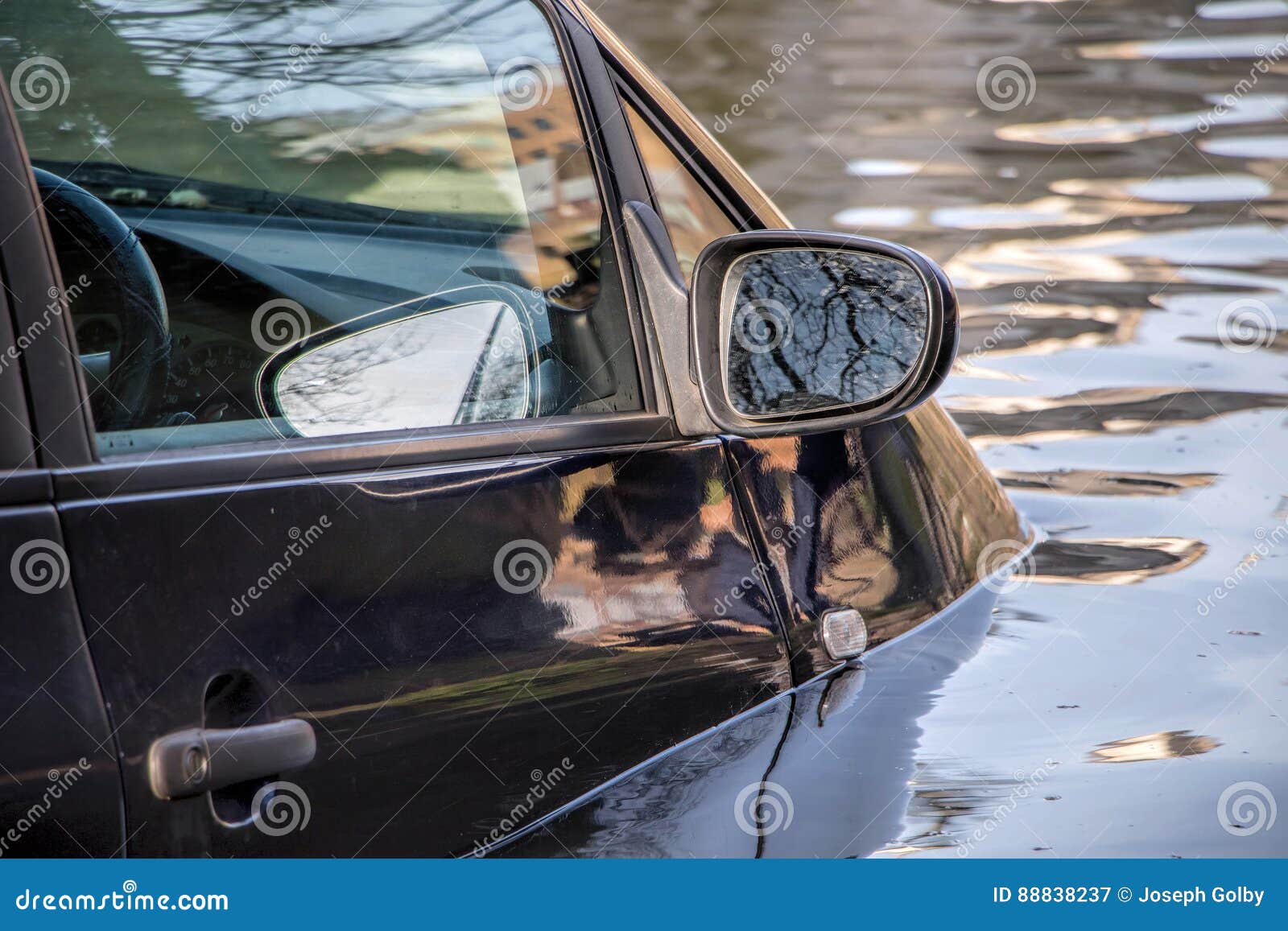 car submerged in flood water.