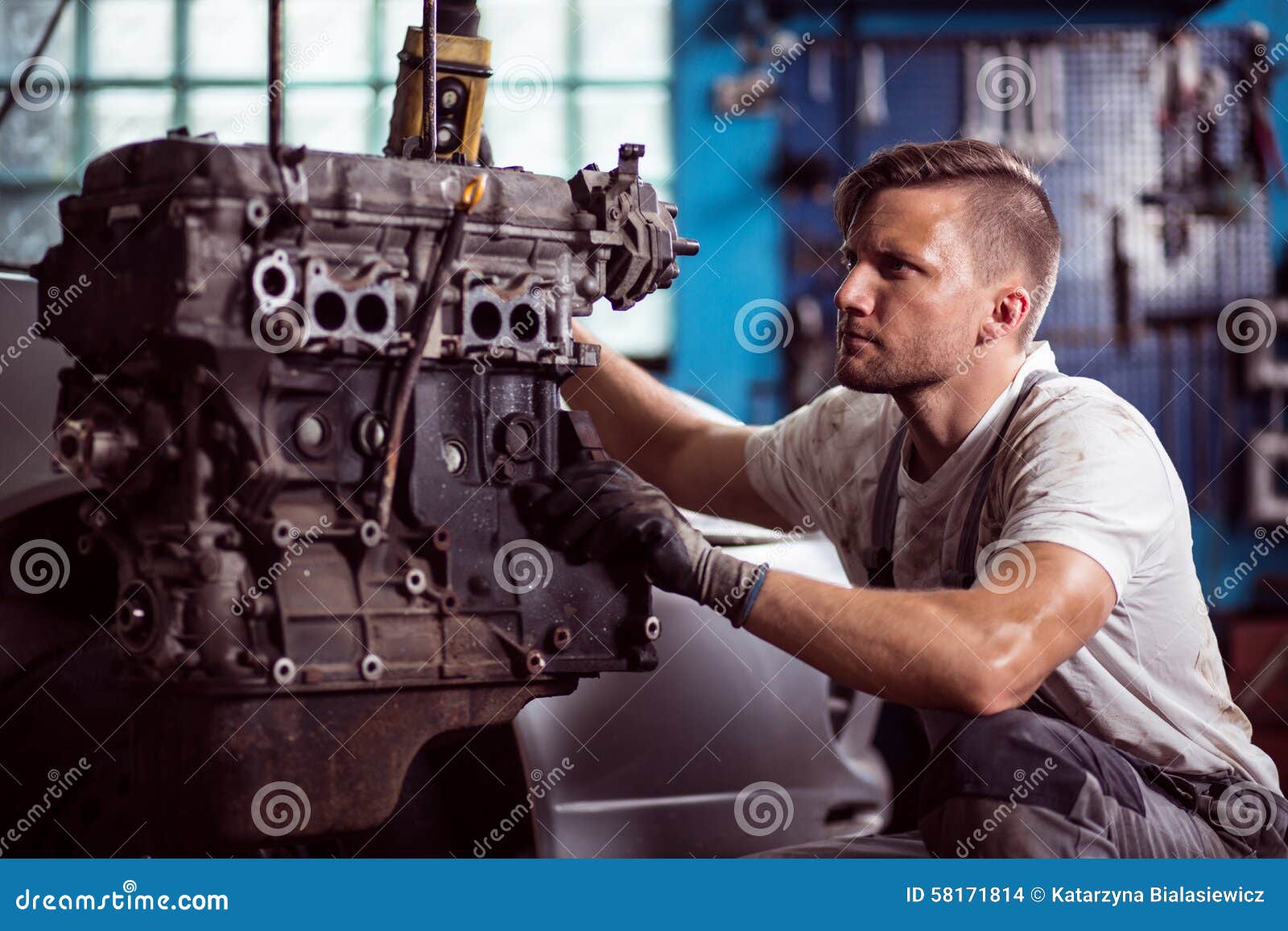 car technician maintaining automotive engine