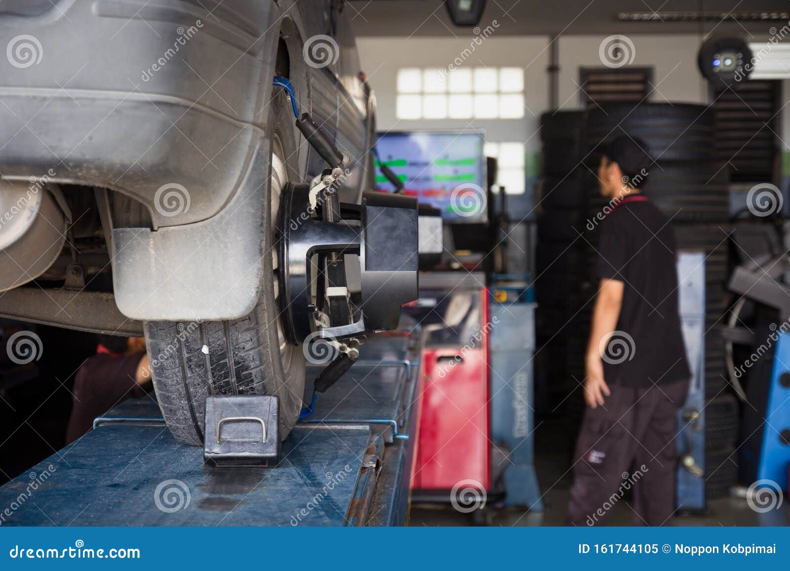 car tyre alignment wheel balance at garage service workshop.