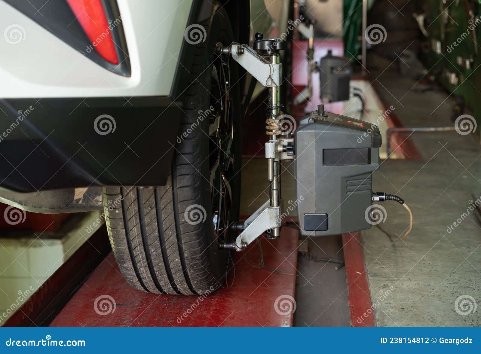 Car Wheel Alignment in Progress at Auto Repair Station Stock Photo Image of aligner, repair