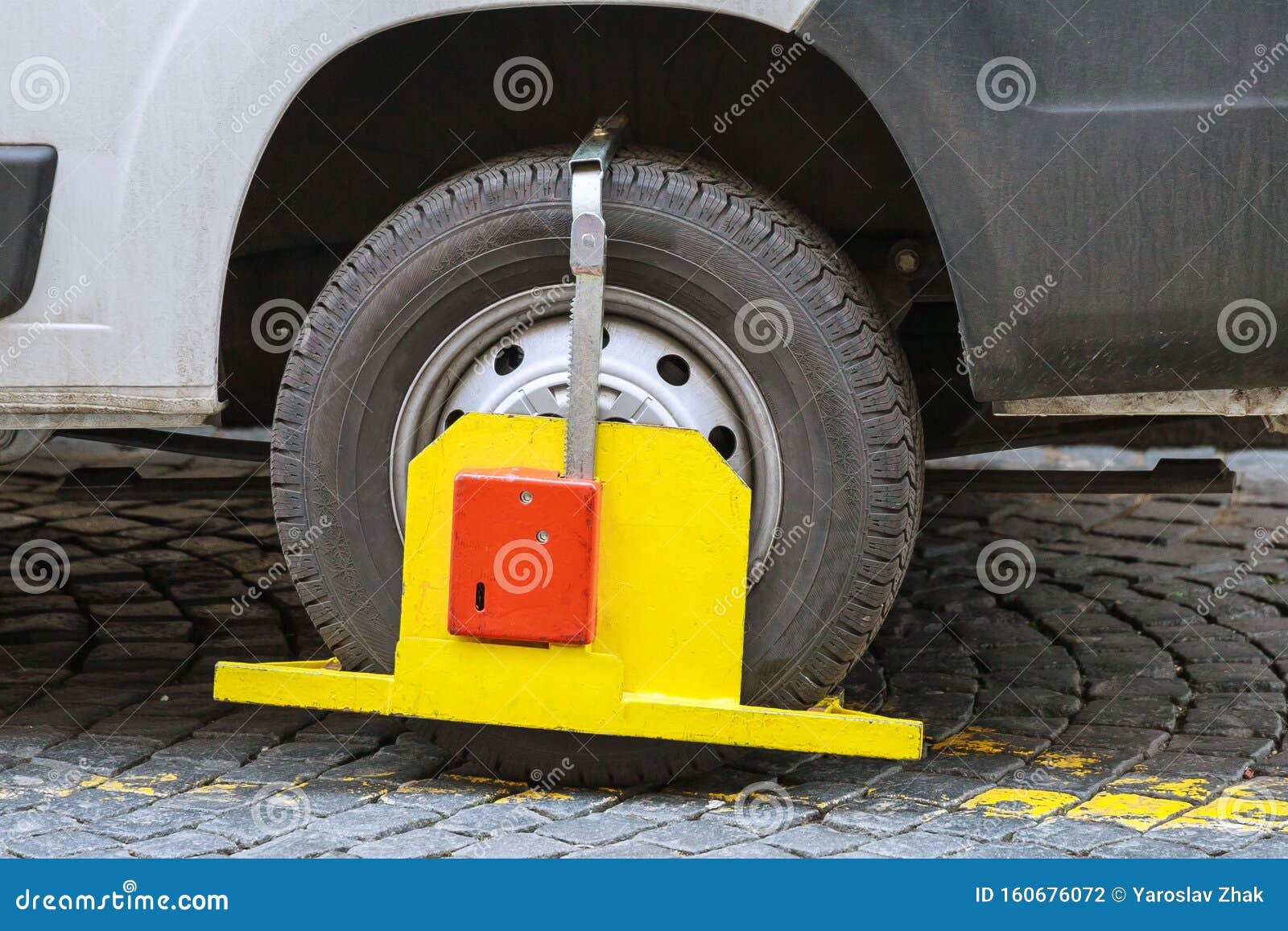 Car Wheel Blocked By Wheel Lock Because Illegal Parking Violation. Red