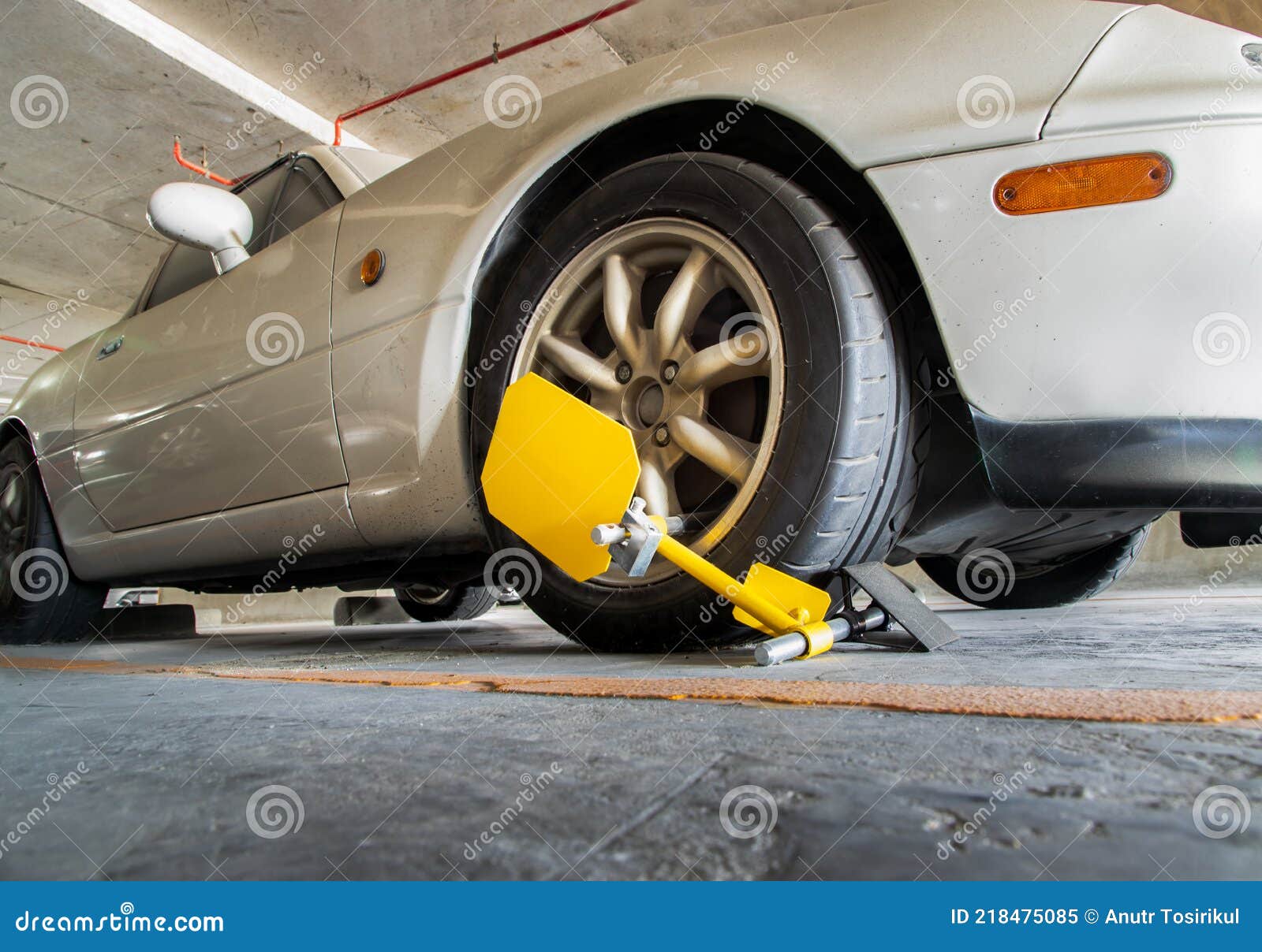 Car Wheel Blocked By Wheel Lock Because Illegal Parking Violation. Red