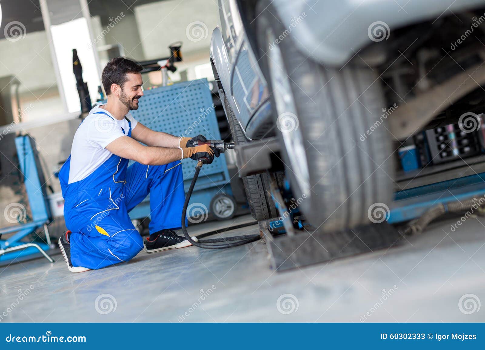 Car Wheel Change by Mechanic Stock Image Image of tool, blue 60302333