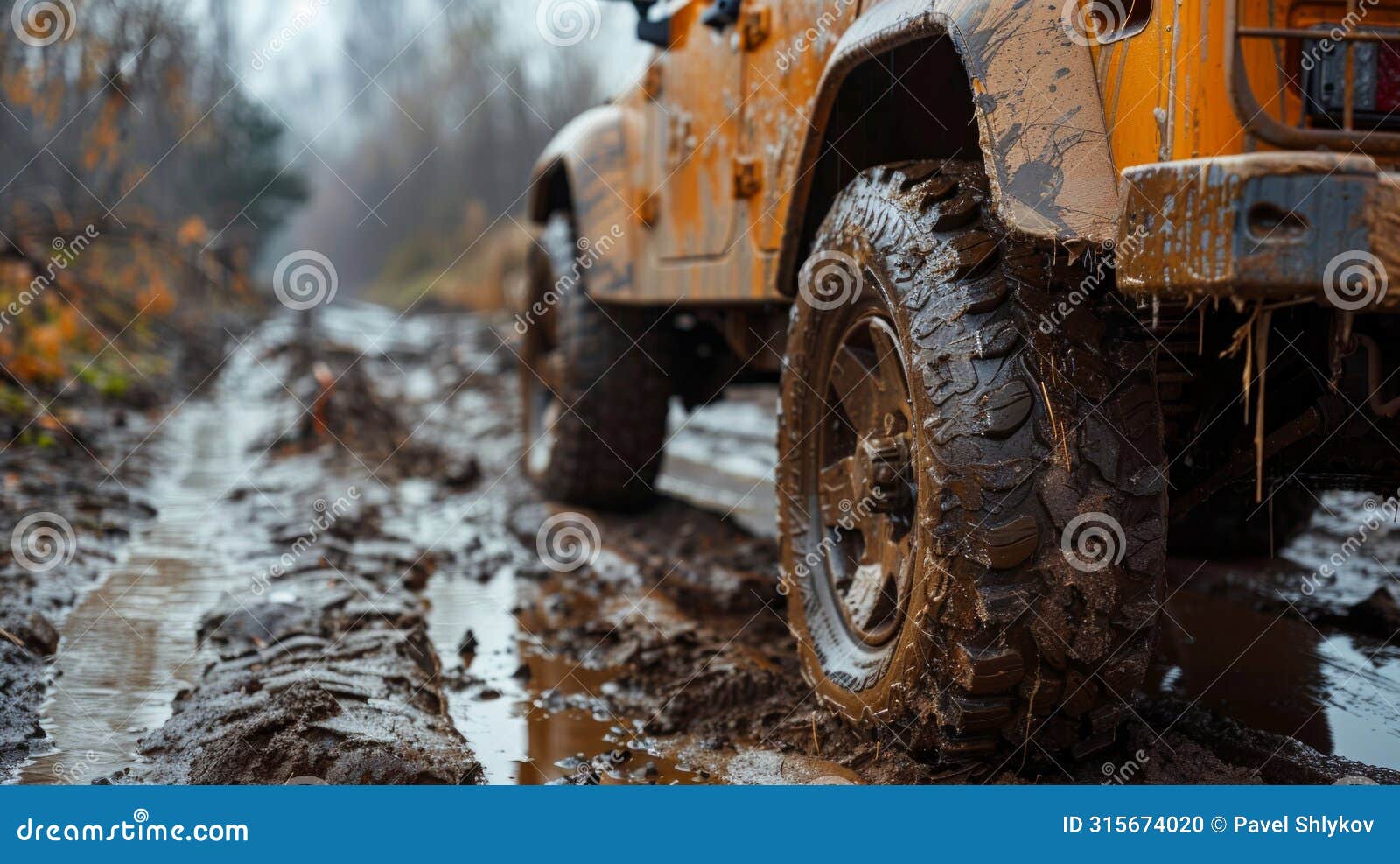 car wheel on dirt road. off-road tire covered with mud, dirt terrain. outdoor, adventures and travel suv. car tire close