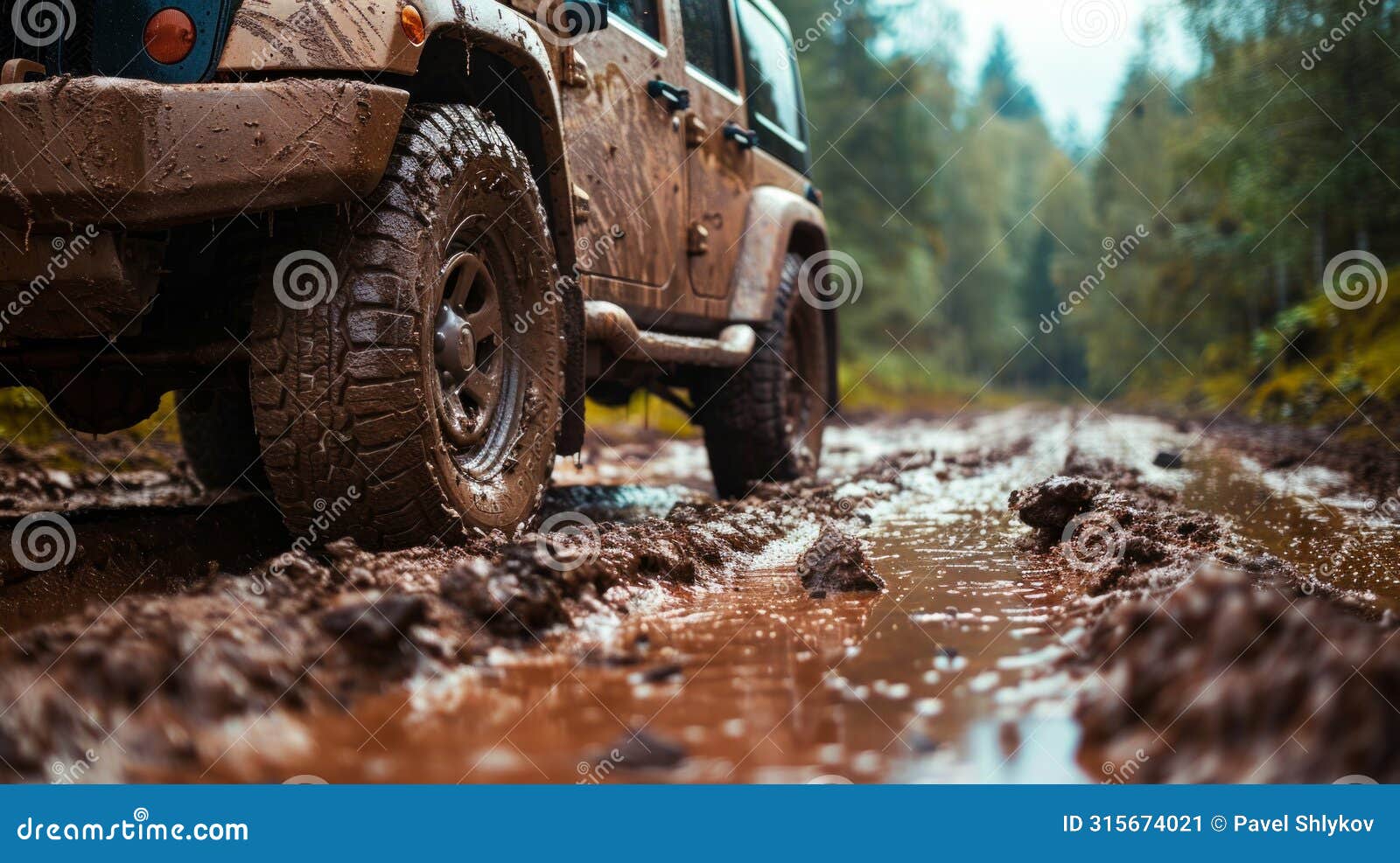 car wheel on dirt road. off-road tire covered with mud, dirt terrain. outdoor, adventures and travel suv. car tire close