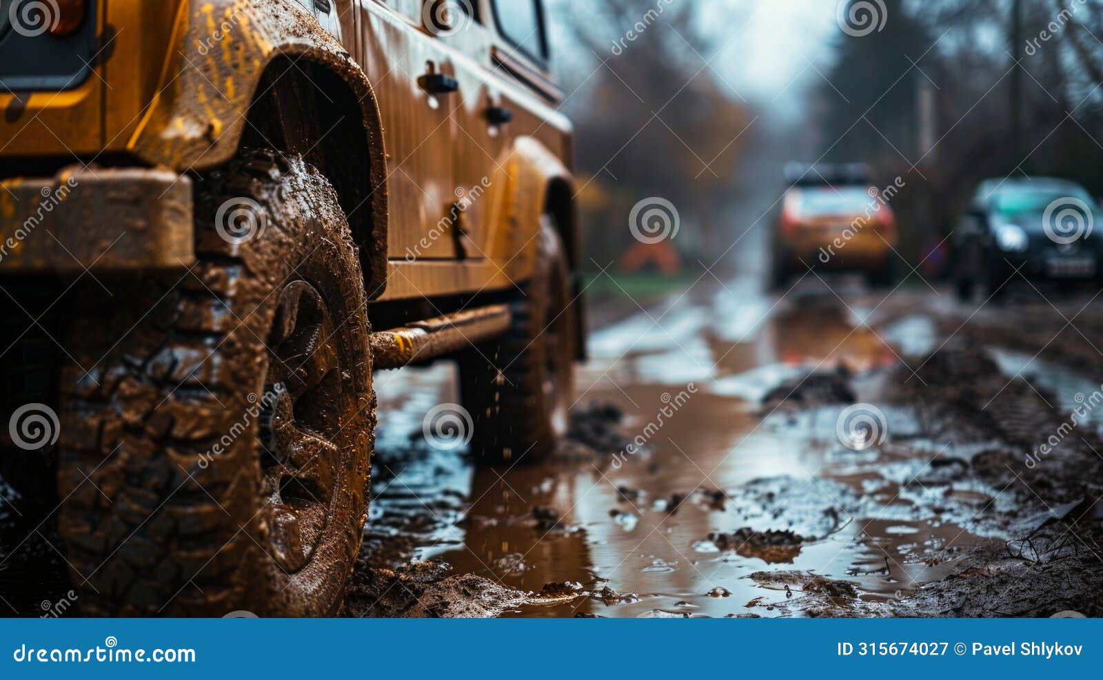 car wheel on dirt road. off-road tire covered with mud, dirt terrain. outdoor, adventures and travel suv. car tire close