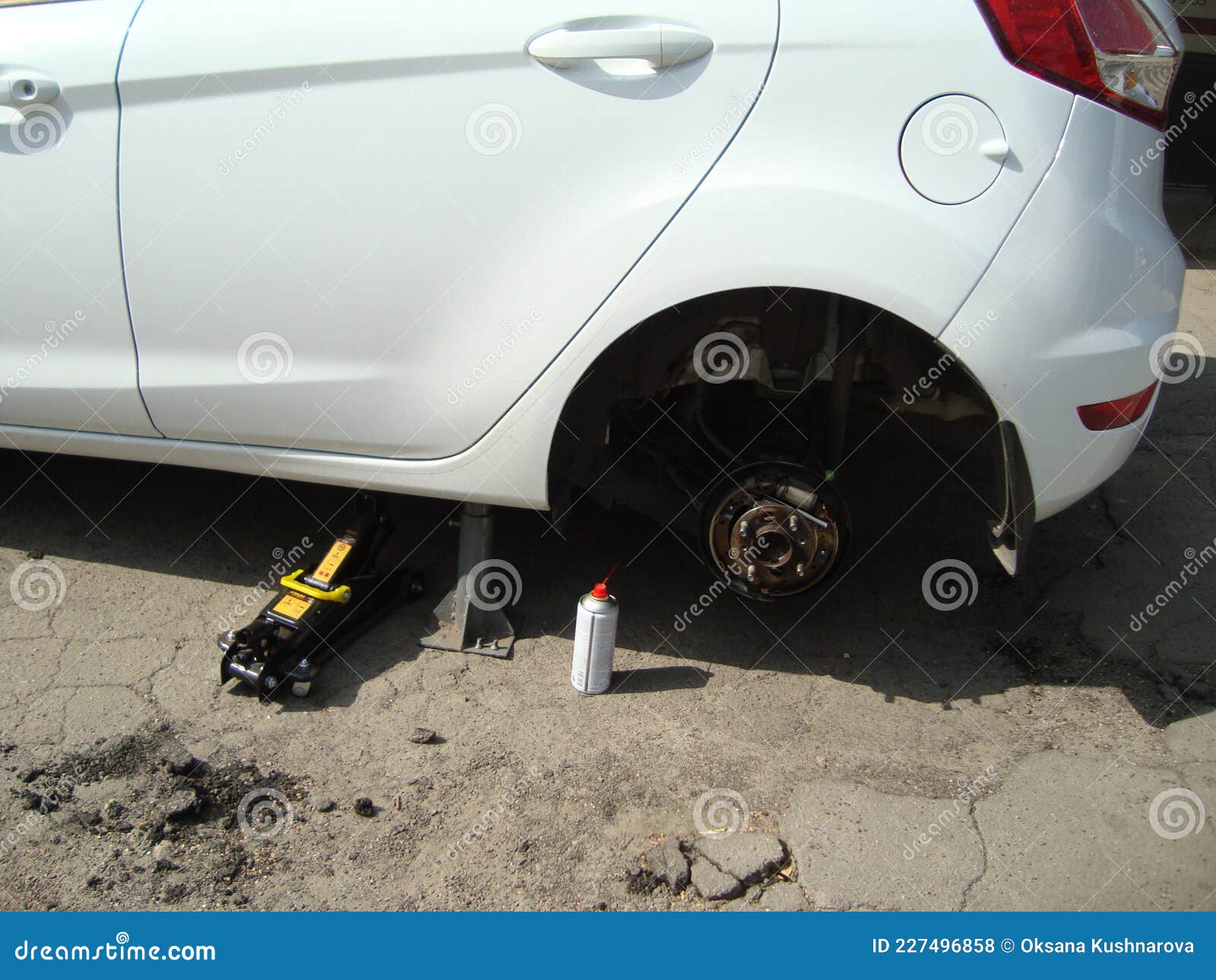 Replacing the Wheel in the Car. Car Service, Small Business Stock Photo