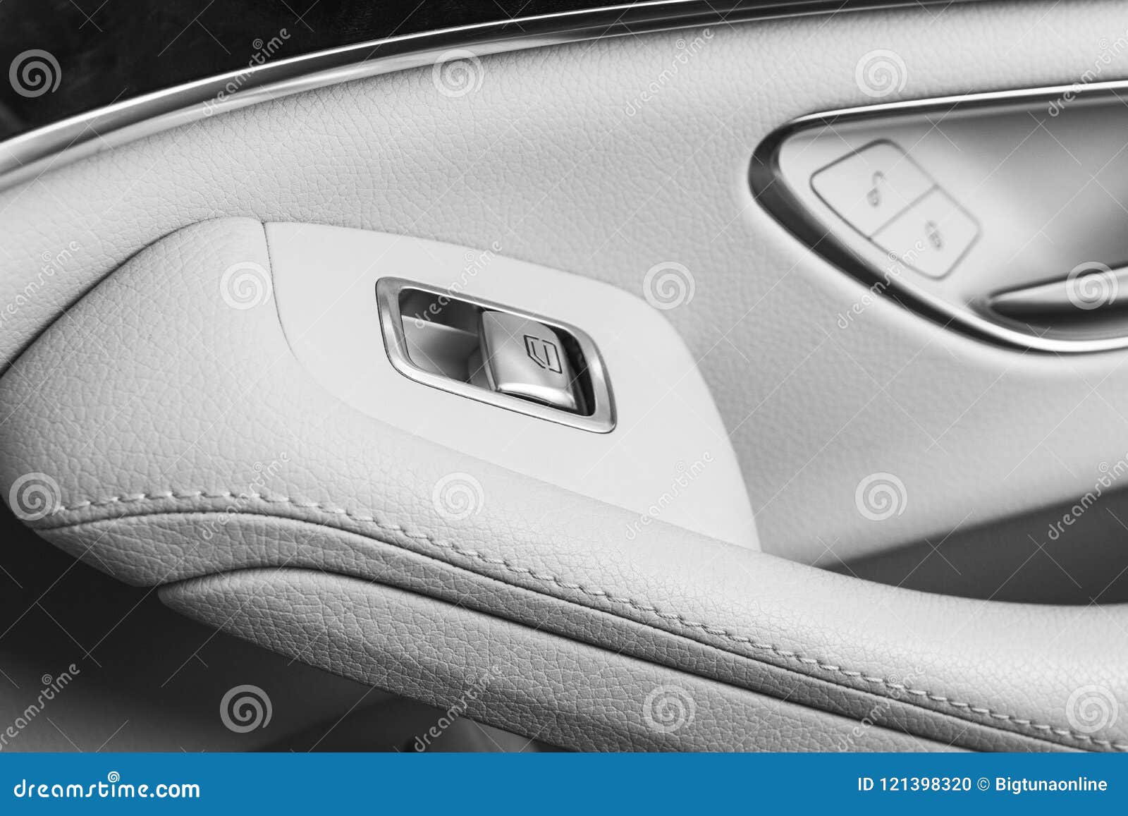 car white leather interior details of door handle with windows controls and adjustments. car window controls of modern car. car de