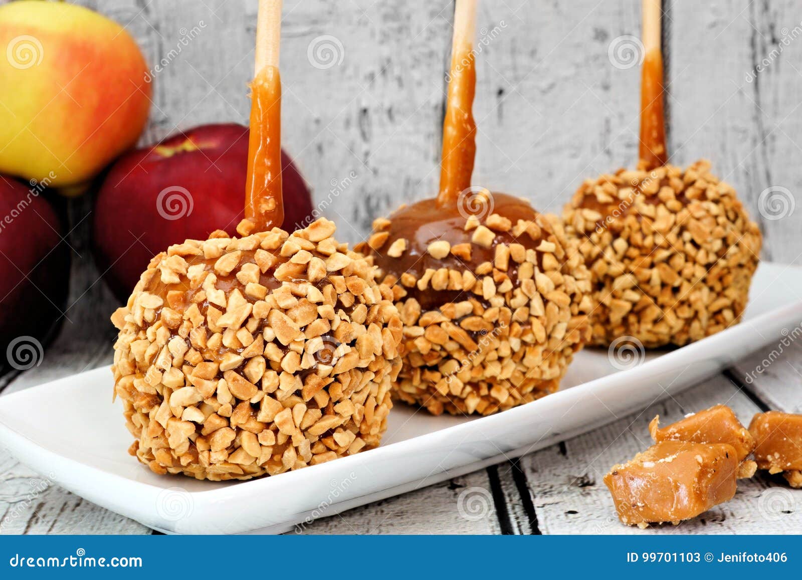 Caramel Apples with Nuts on a Plate Against White Wood Stock Image