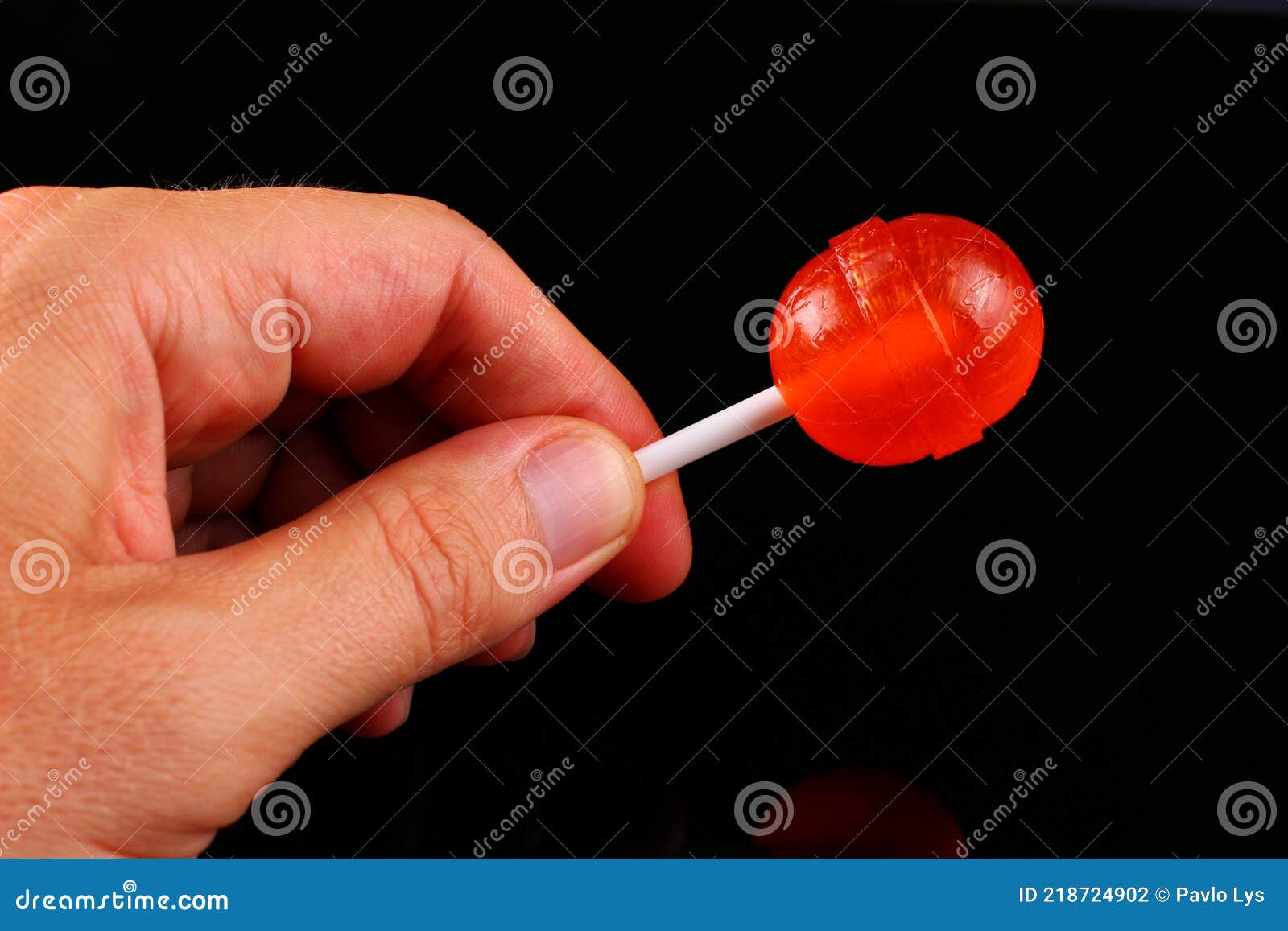 Caramel Candy on a Stick in Hands Stock Photo Image of spicy, lollipop 218724902