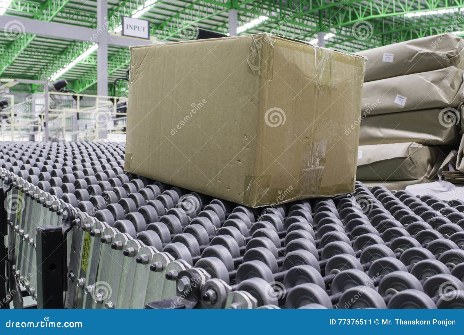 Cardboard Boxes on Conveyor Belt in Distribution Warehouse. Stock Image
