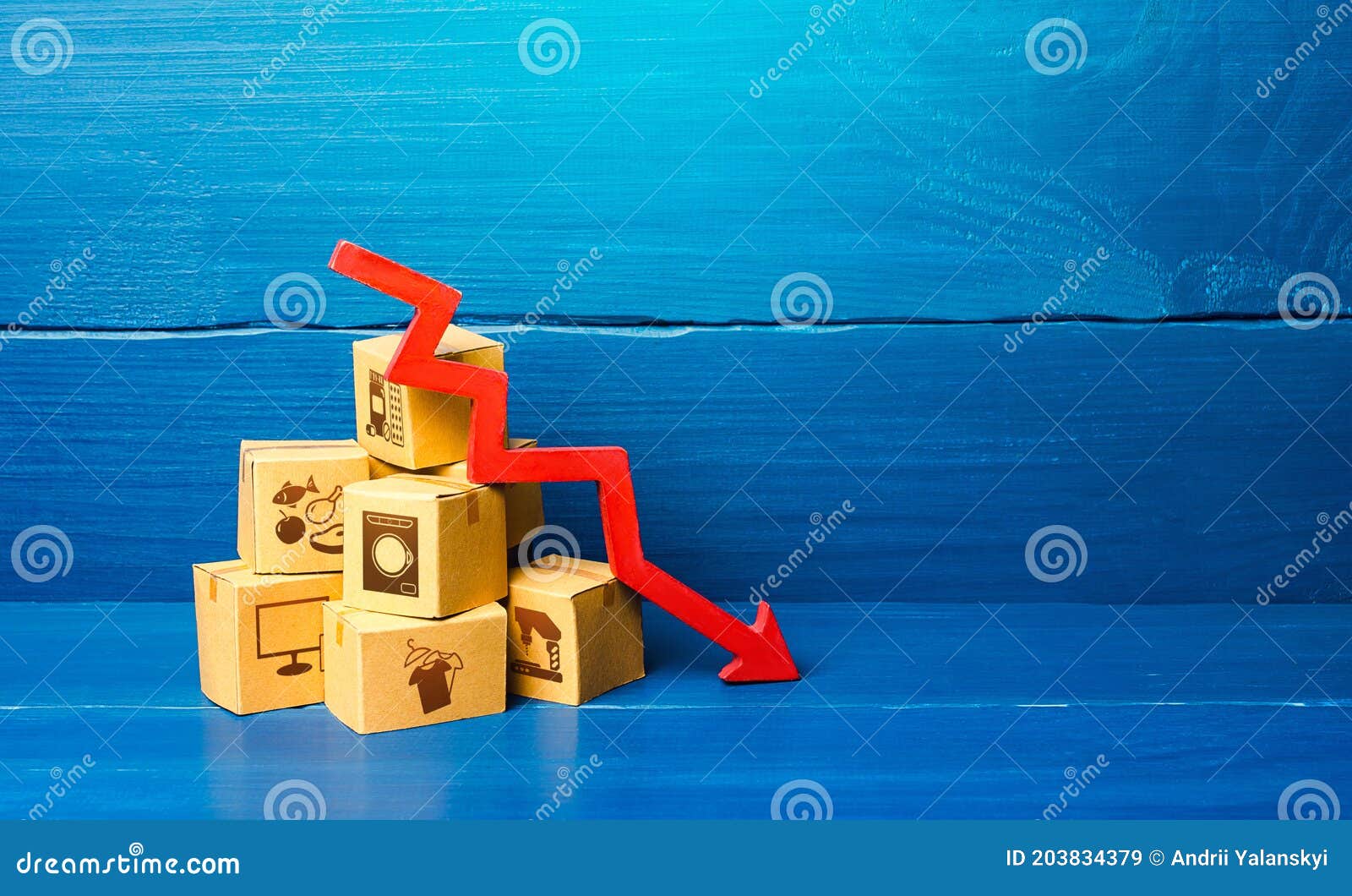 cardboard boxes and red down arrow. decline in sales and production volumes. depressed economy. low business activity